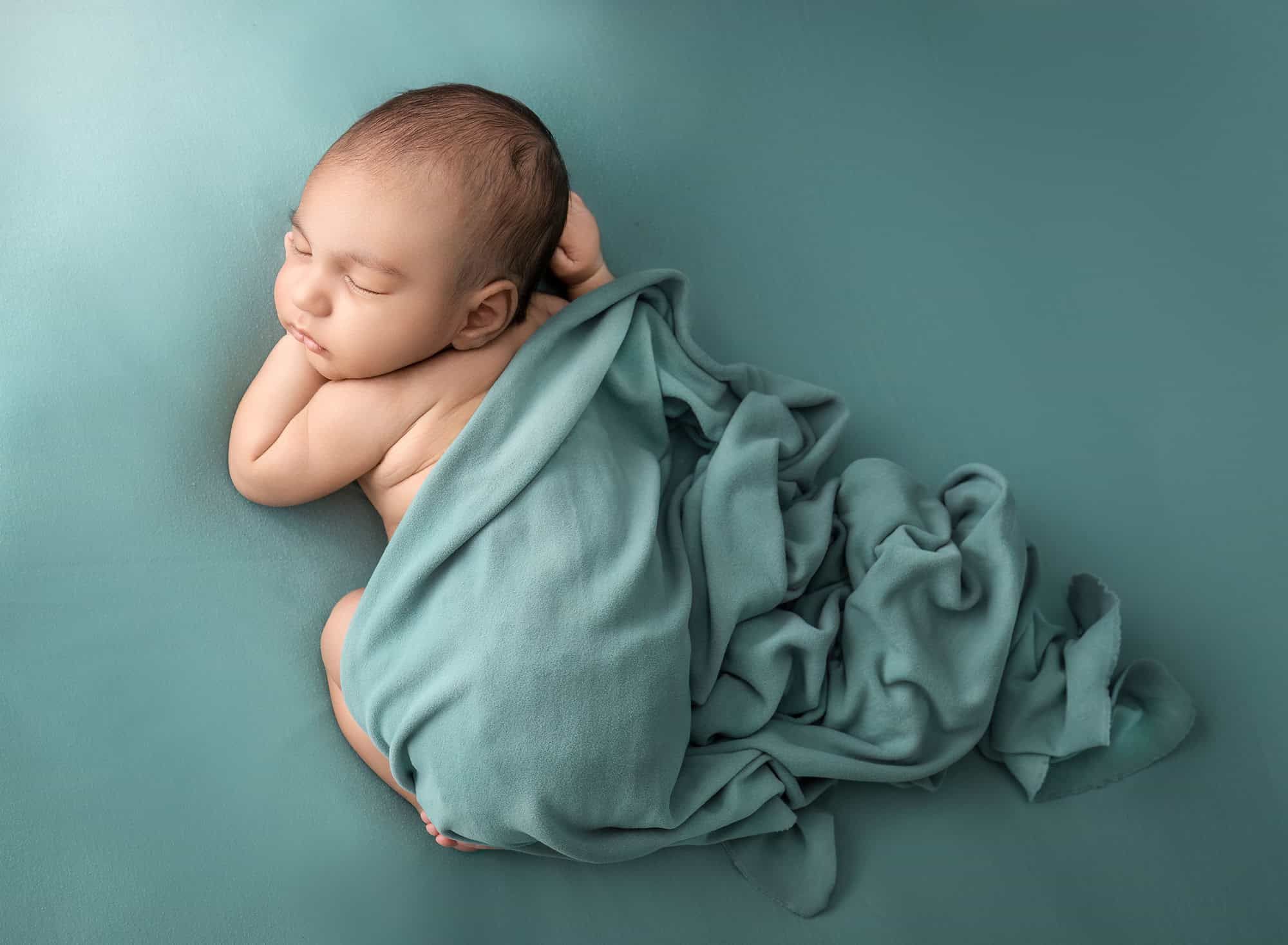 CT newborn photography newborn sleeping with a curled up fabric