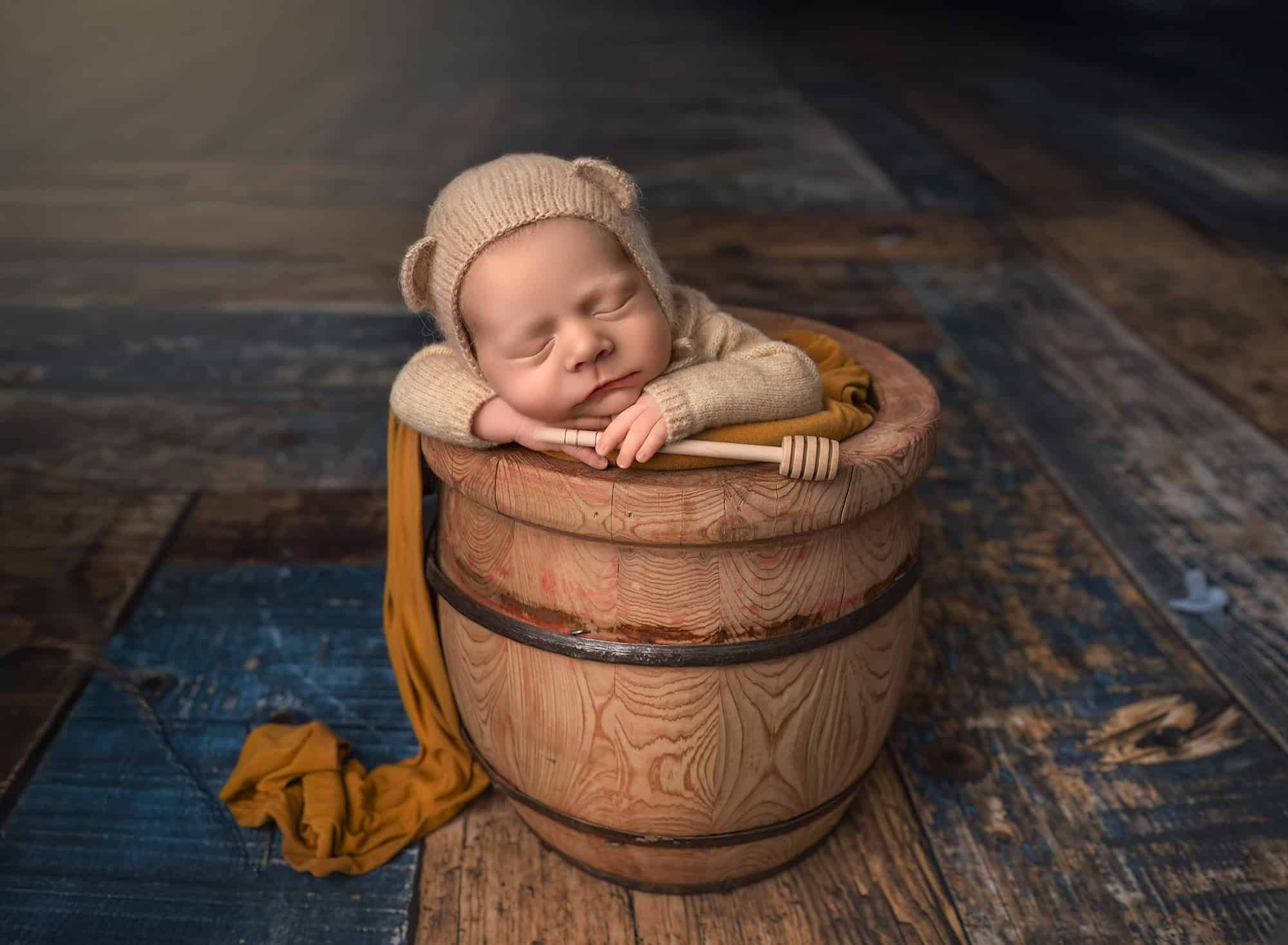 CT best newborn photographer newborn baby sleeping in a bucket with teddy bear ears and honey stick
