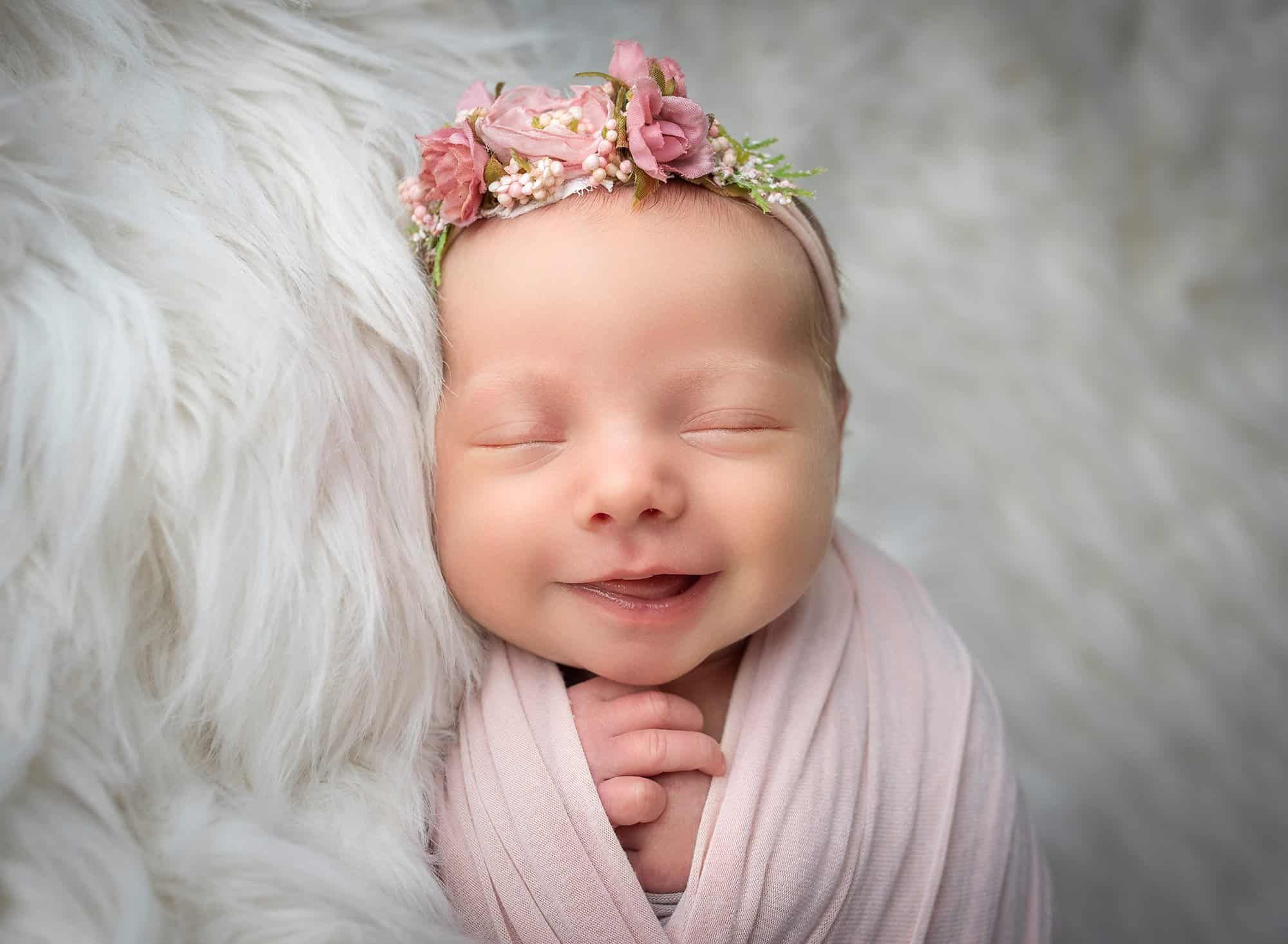 newborn baby smiling