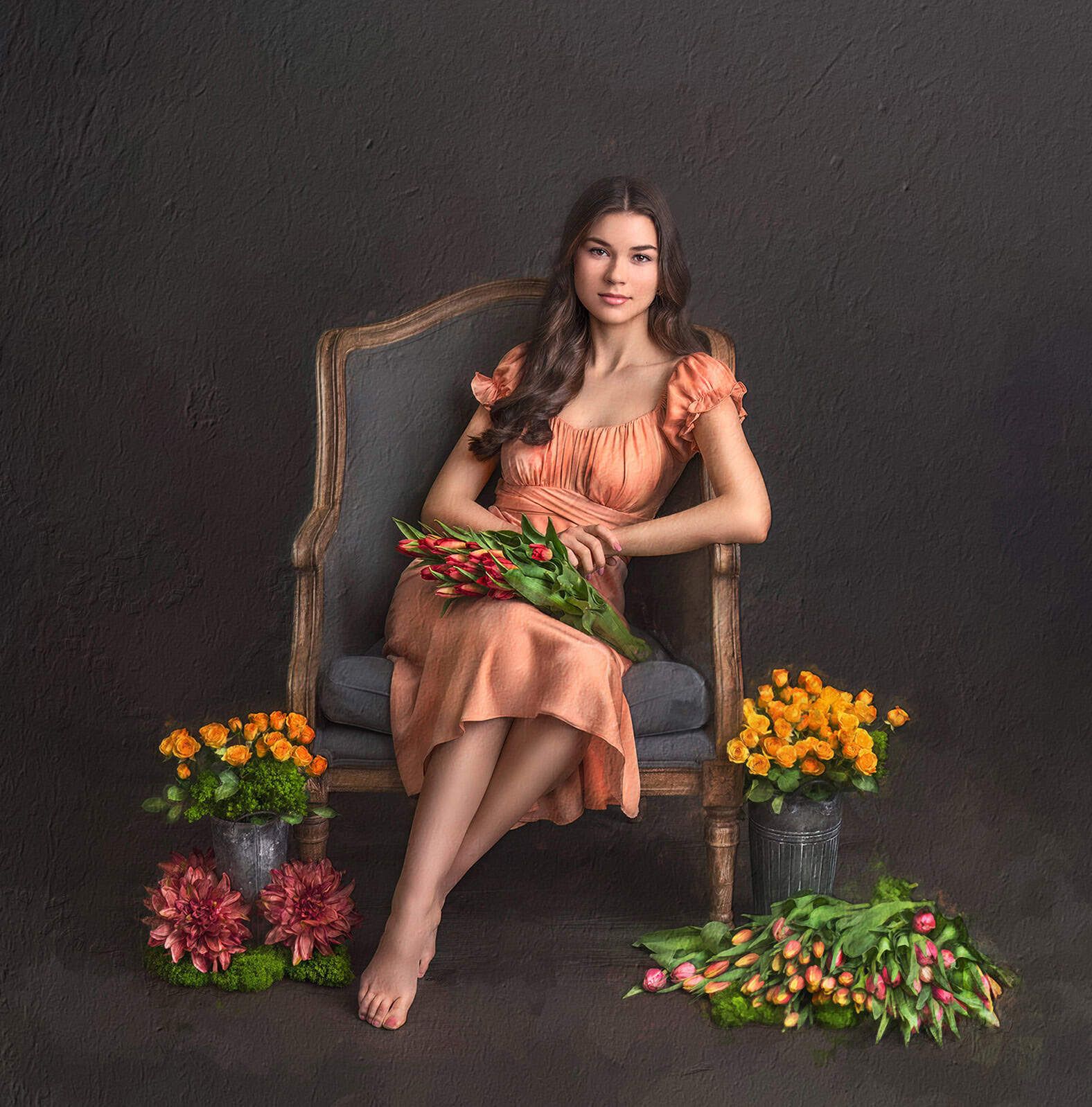 hand-painted canvas portrait of a young woman seated holding tulips on her lap and flowers around her feet