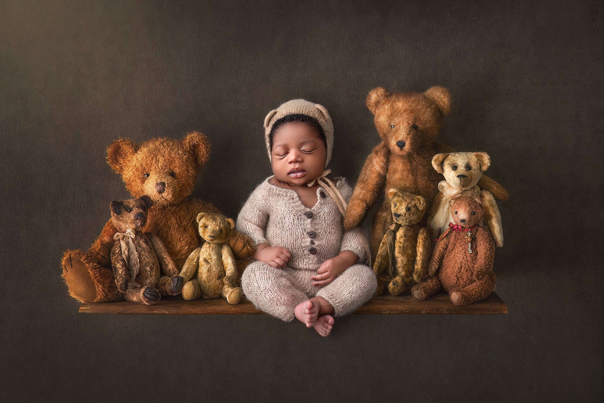 Glastonbury baby photographer newborn baby sleeping with teddy bears on a shelf