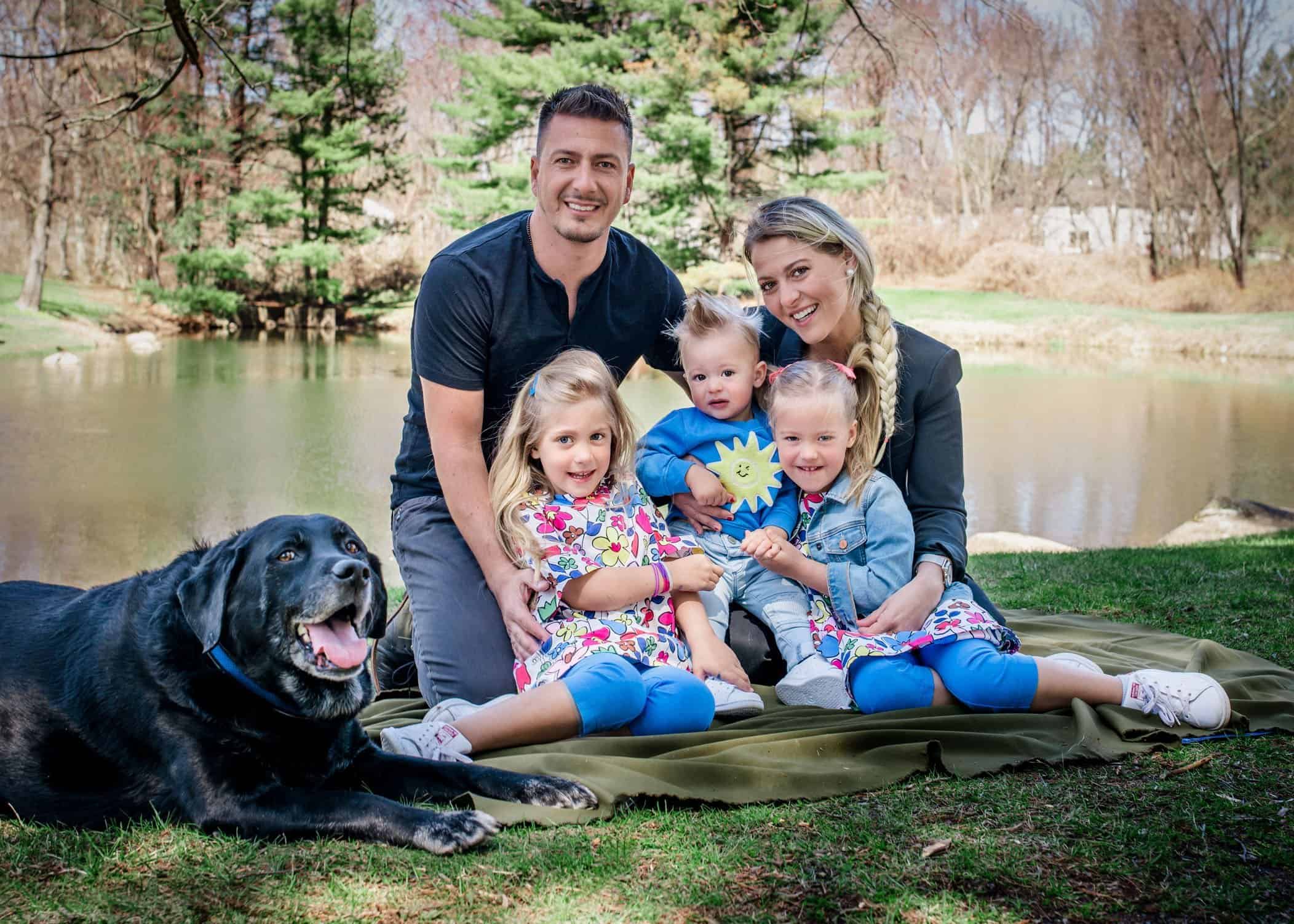 Family of 5 with their dob in front of pond at park for family photo shoot