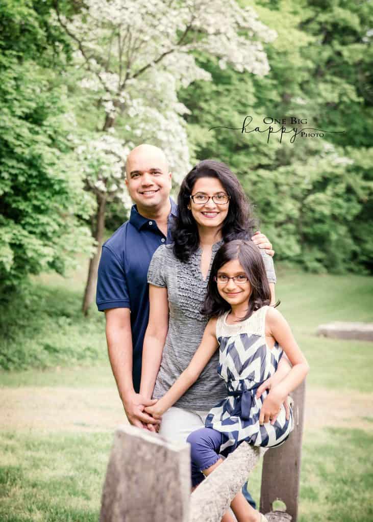 Dad, Mom and daughter standing portrait all holding hands