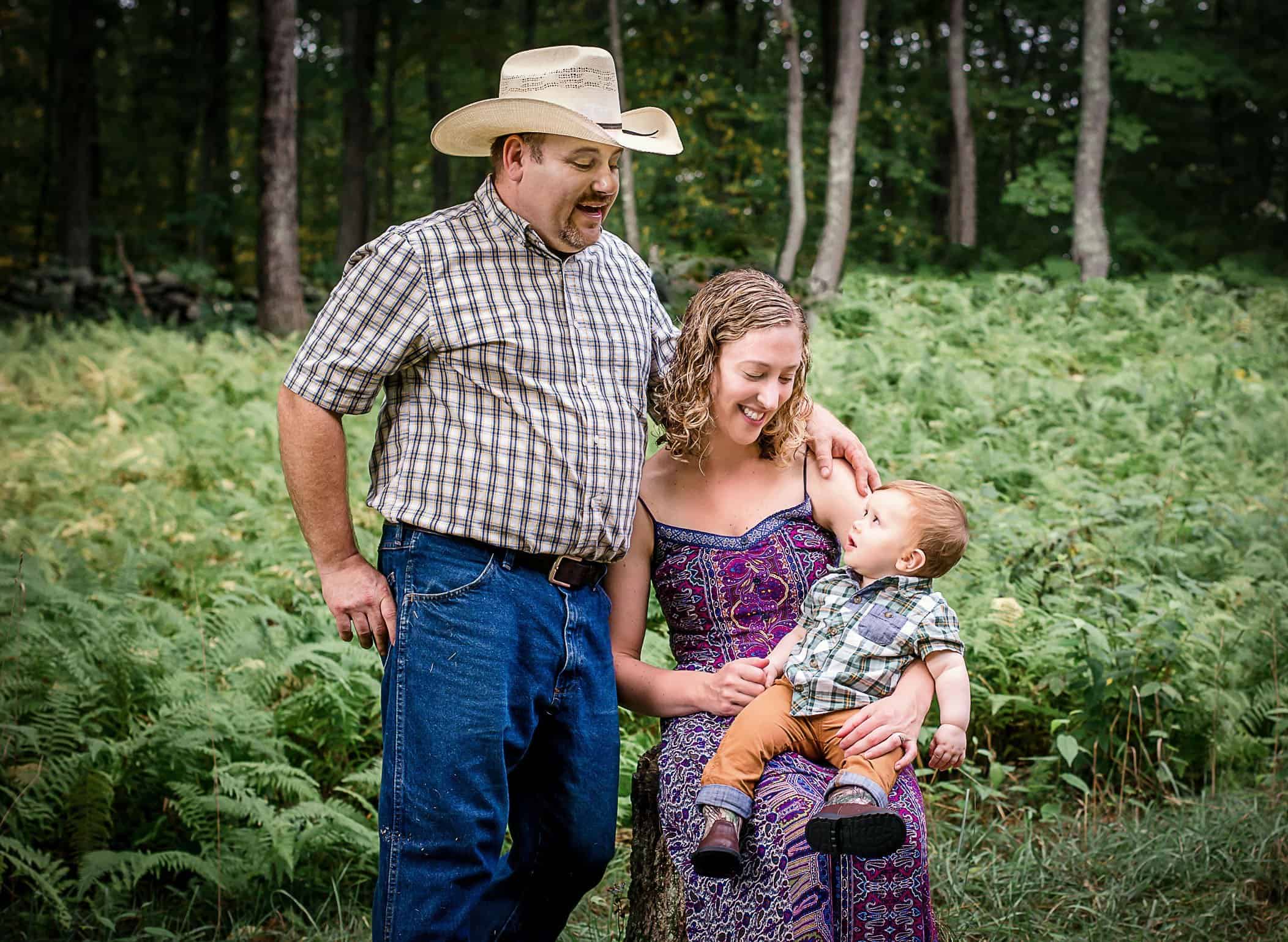 9 mo old baby boy sitting on Mama's lap looking up at Daddy outside One Big Happy Photo