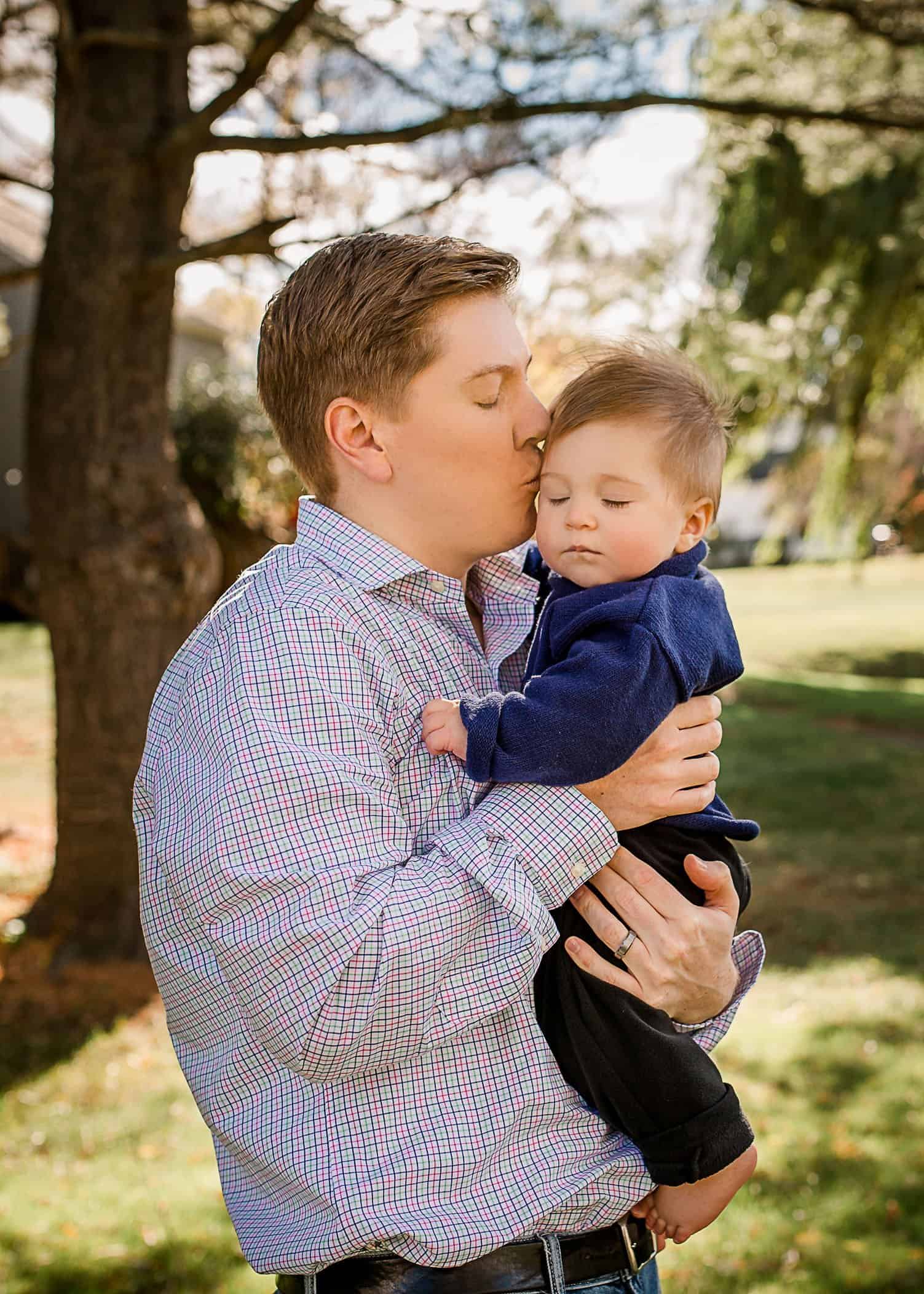 Daddy holding 6 mo old baby boy eyes closed One Big Happy Photo