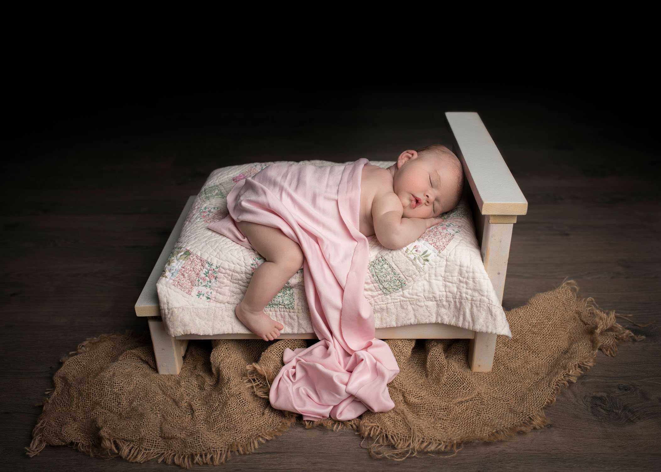 newborn baby sleeping on baby bed