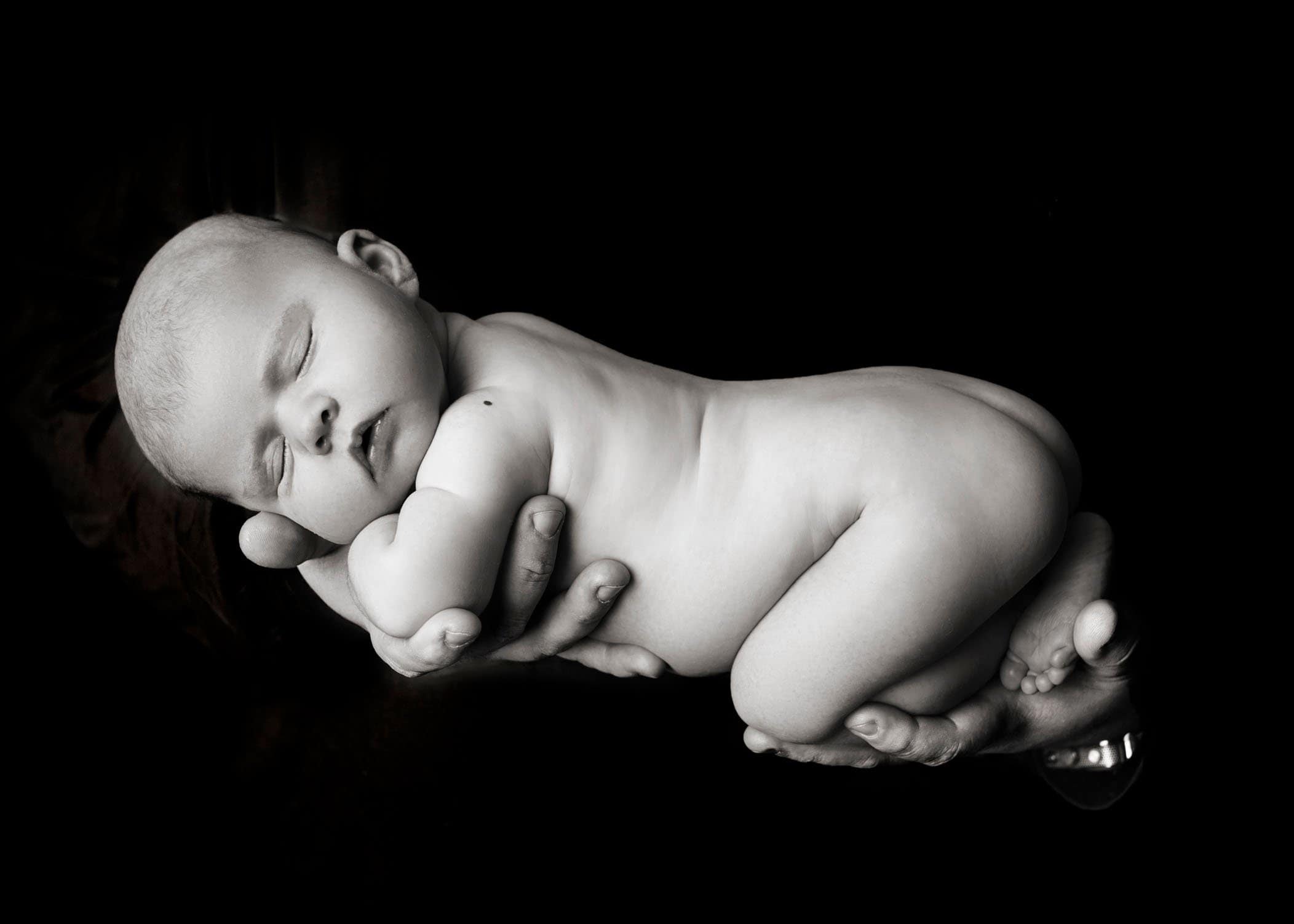 newborn baby girl in Daddy's hands