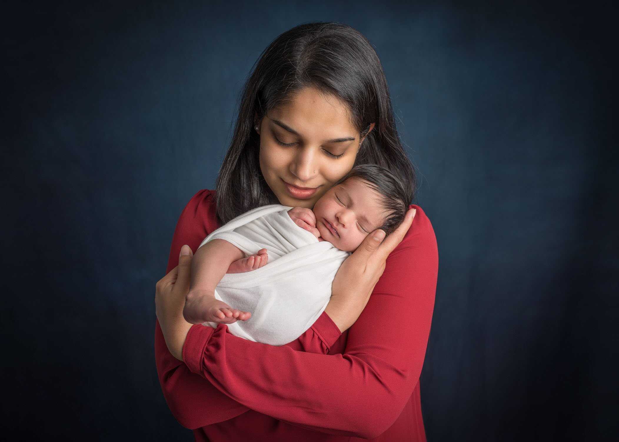 mom holding newborn baby girl