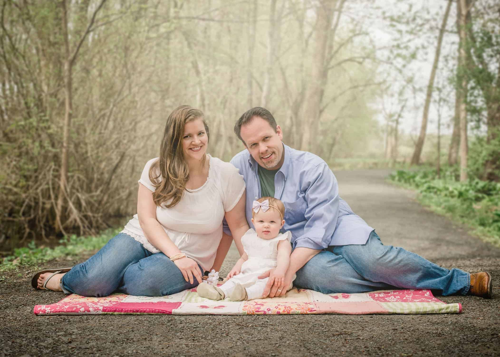 9 mo old baby girl sitting on path on blanket in garden