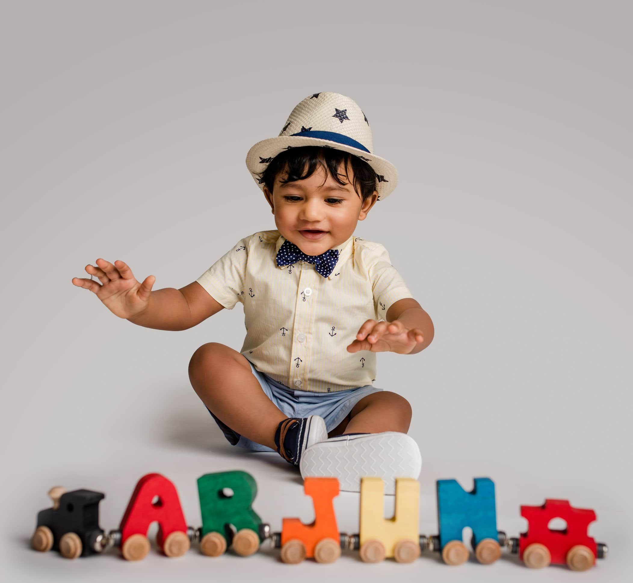 8 mo old boy playing with his name train