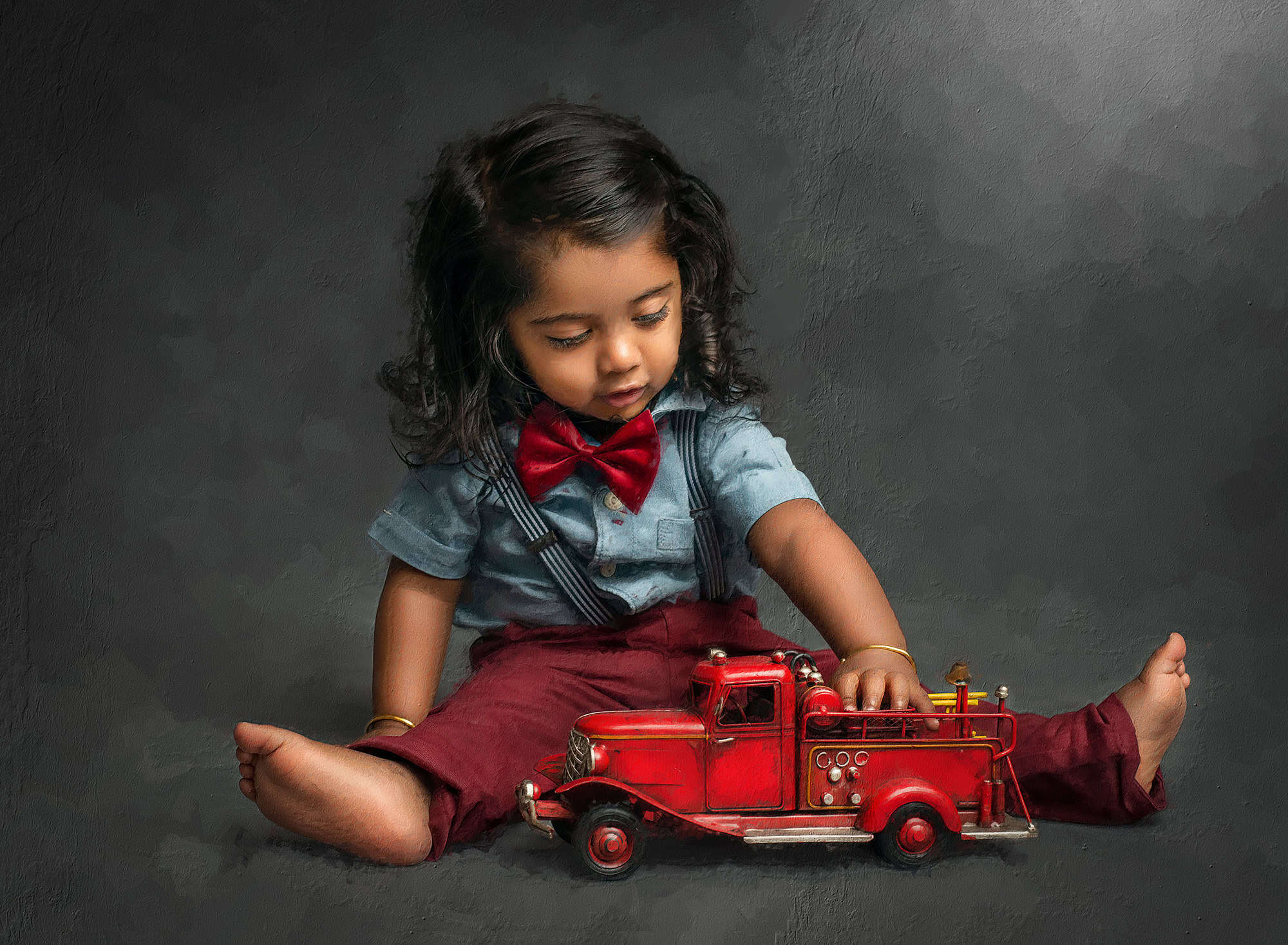 hand-painted canvas portrait toddler boy playing with a firetruck