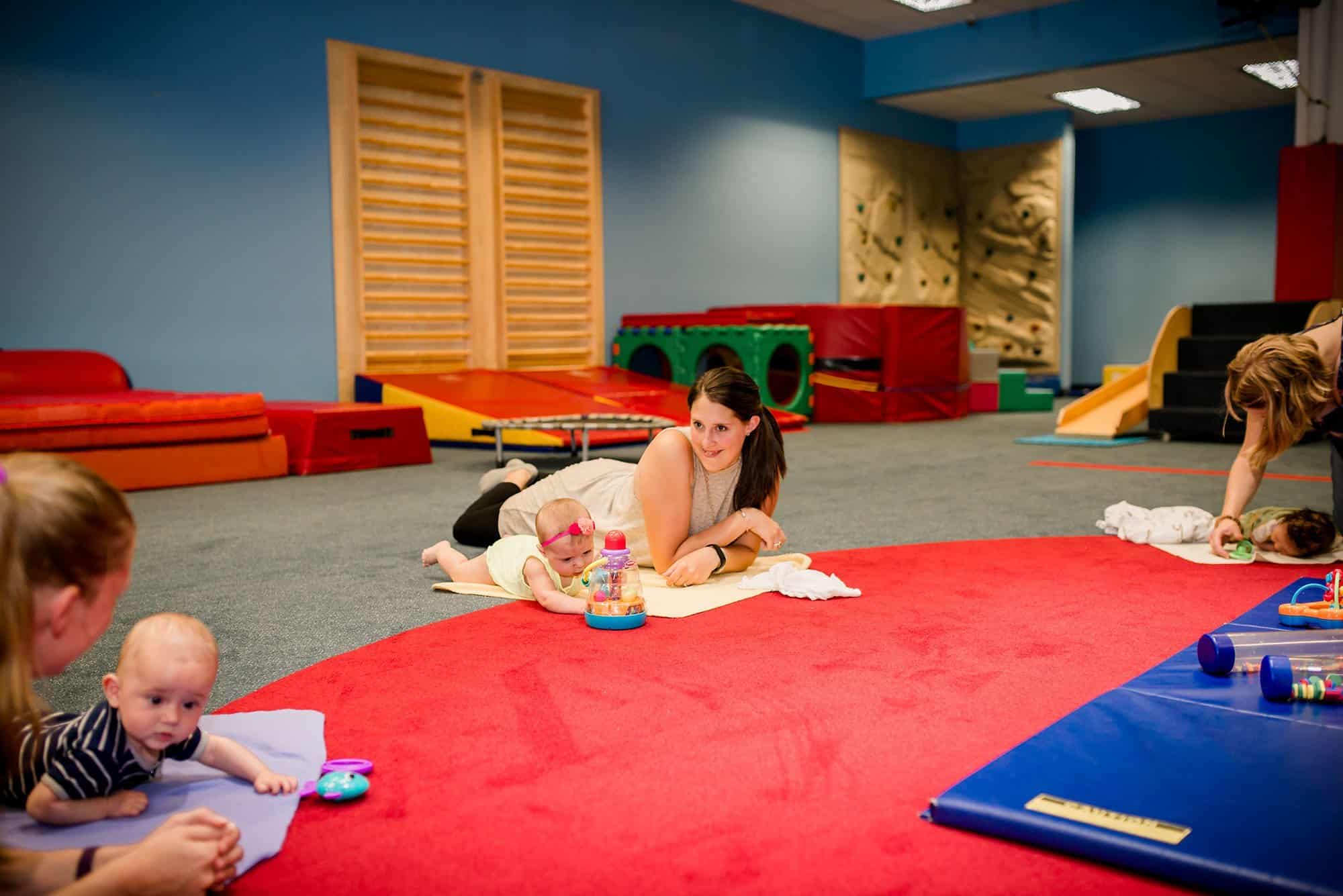 Moms enjoying each other's company as their baby's play during tummy-time