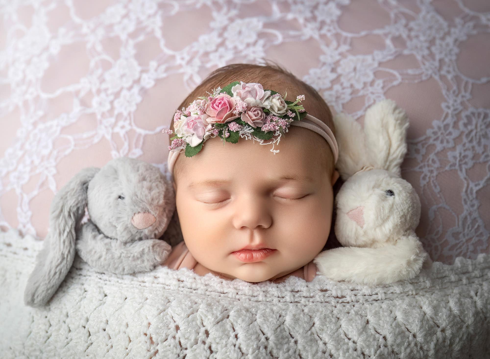Connecticut newborn photographer Close-up with plush bunnies — Newborn headband and lace textures with soft toys.