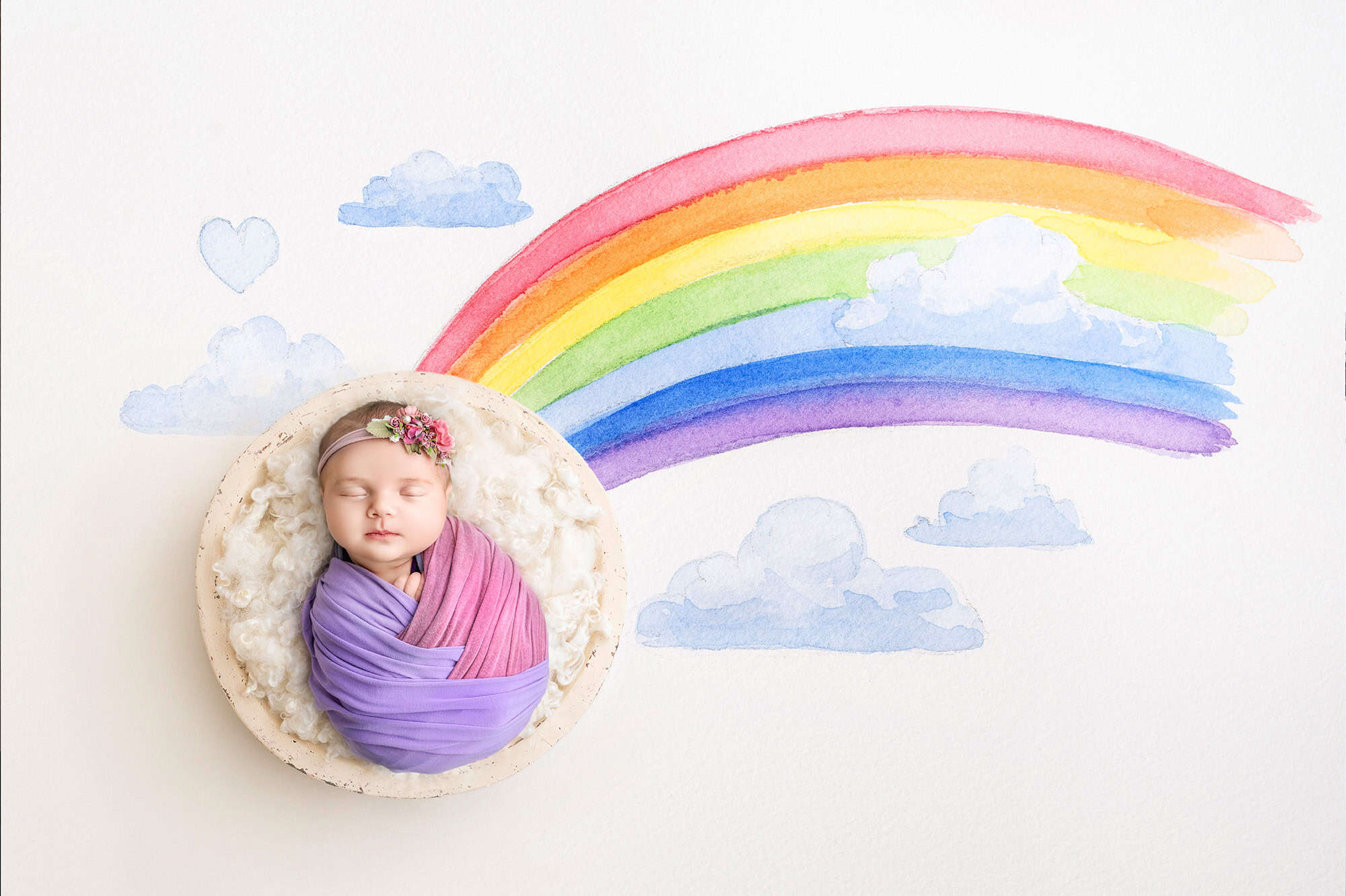 Rainbow backdrop newborn picture — Baby in a round bowl with watercolor rainbow.