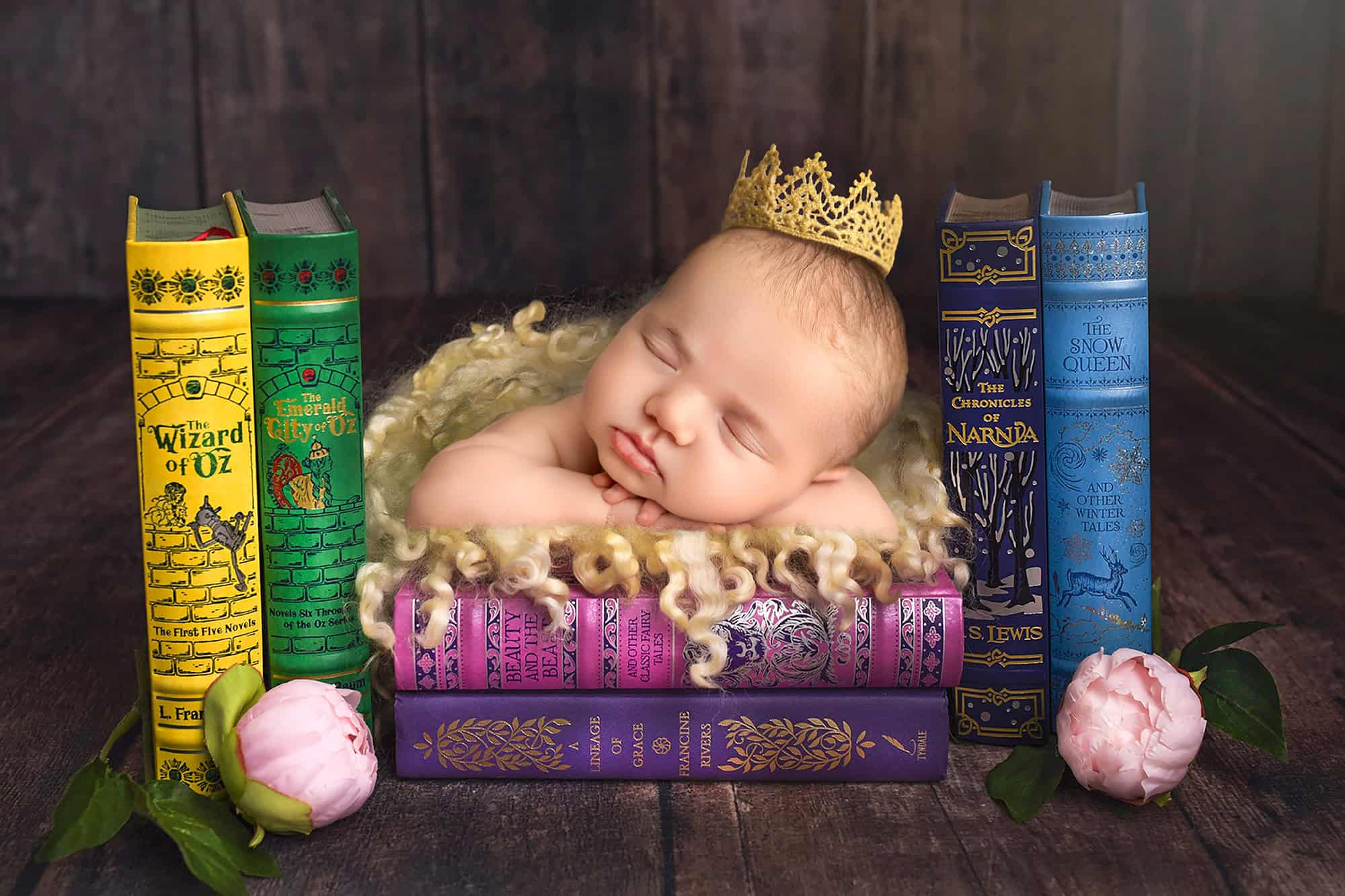 Connecticut newborn photographer Storybook newborn portrait — Baby Mia sleeping with a crown between classic fairy-tale books.