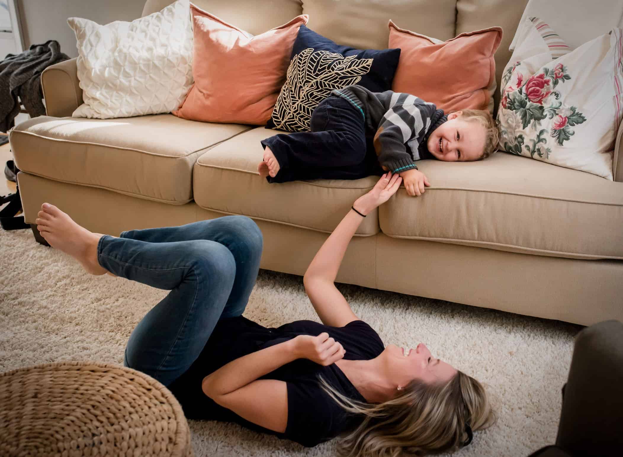 Mom and young son playing in living room