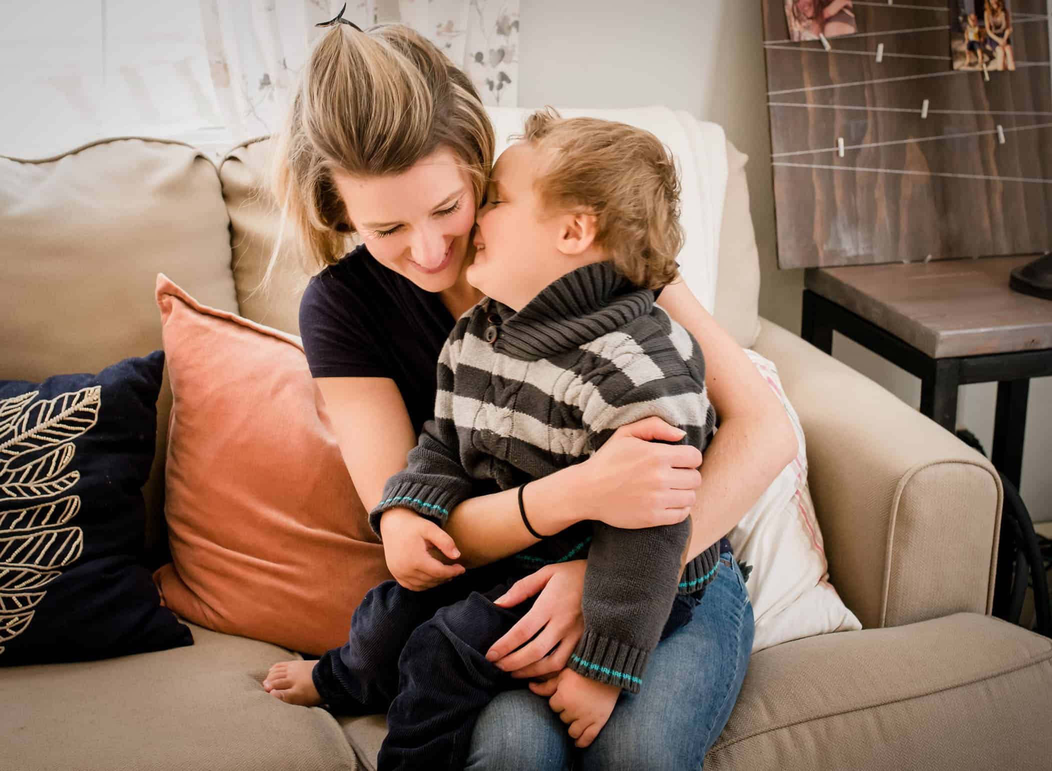 4 year old boy giving mom a kiss on the cheek