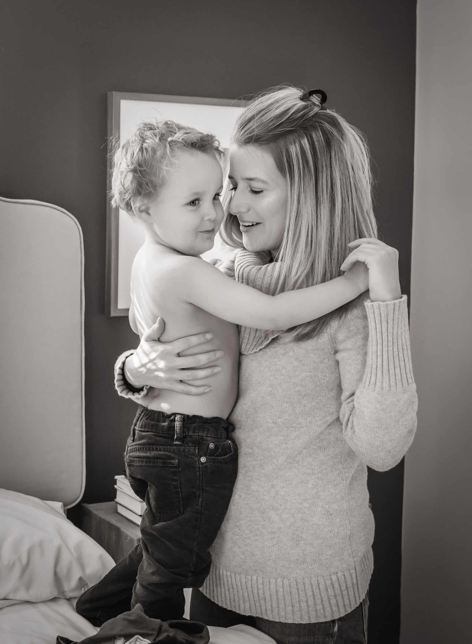 Mom cuddling toddler son