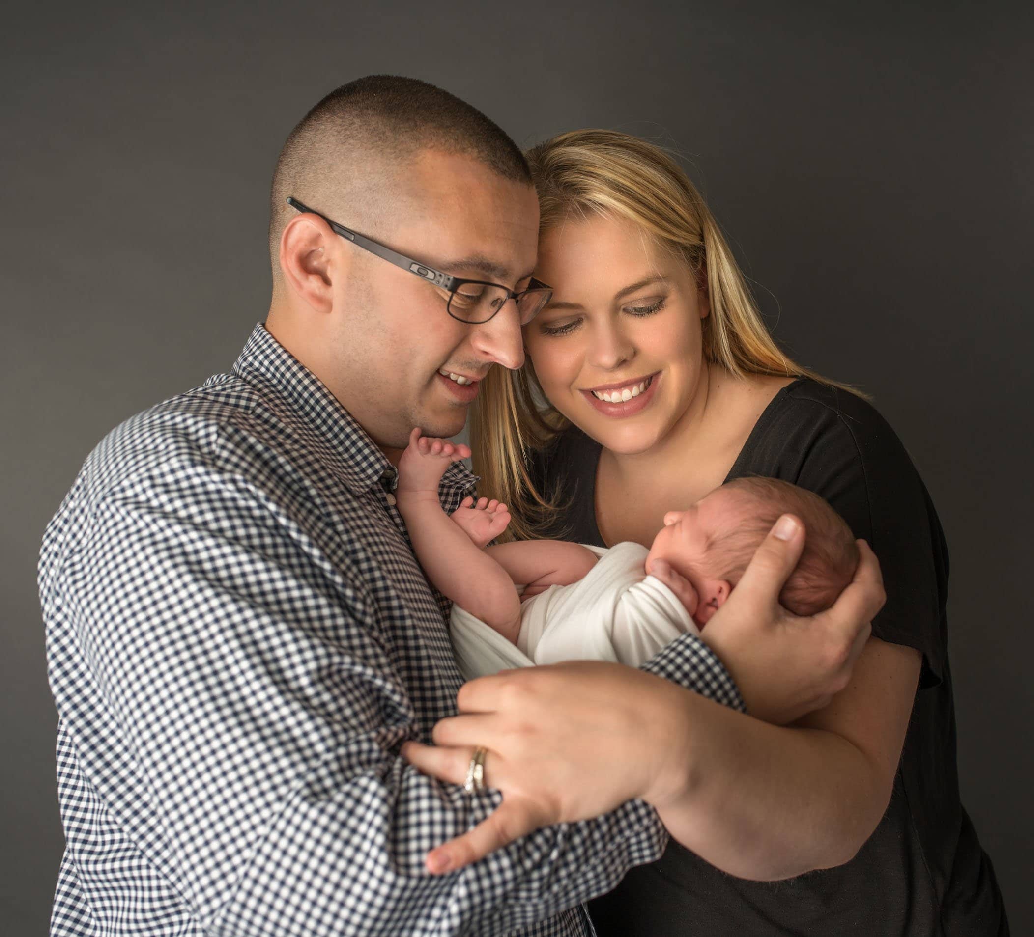 Mom ad Dad holding their 4th child but first daughter