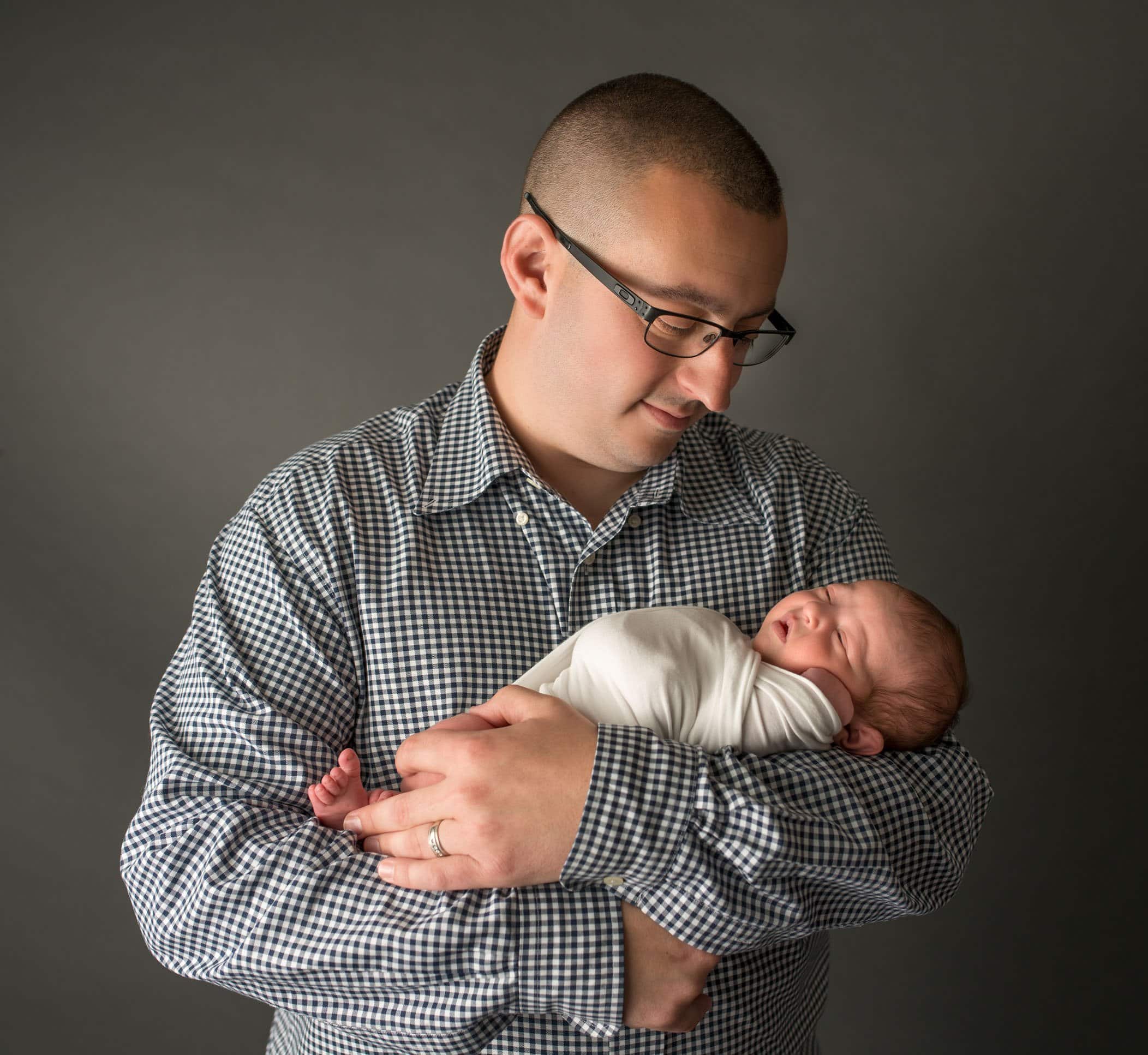 Dad holding his 4th child but first daughter