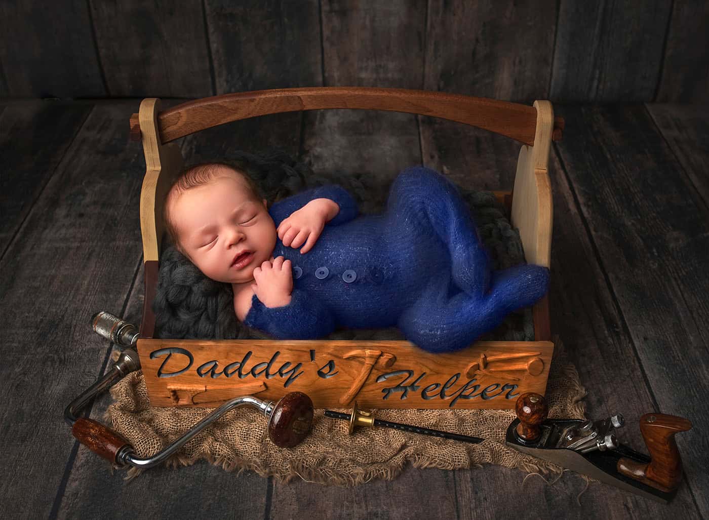 heartwarming image of him nestled in a tool box with "Daddy's little helper" engraved on the side