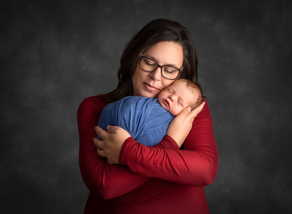 the tender embrace of a mother cradling her newborn son