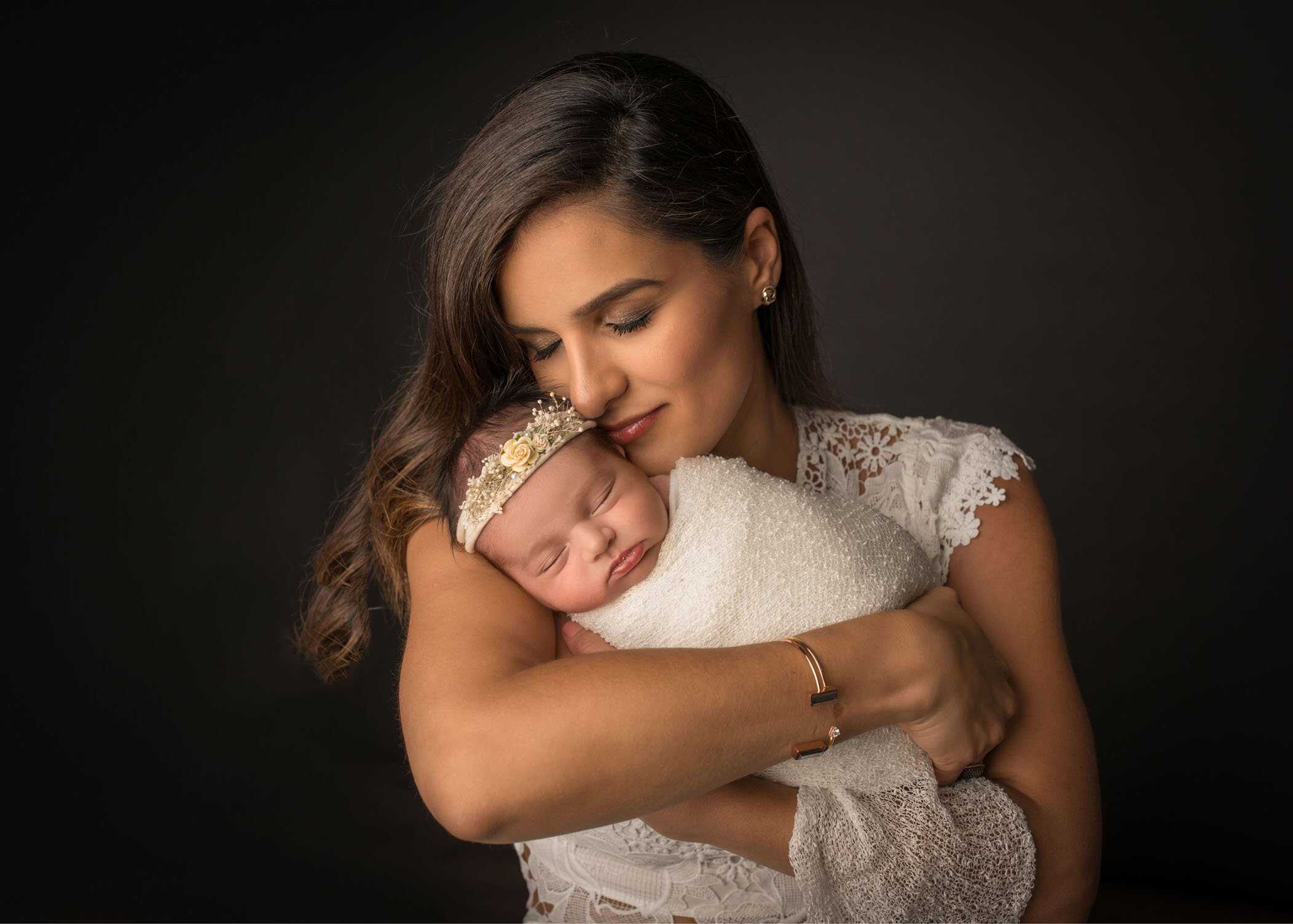 Mom cradling newborn daughter in the moment