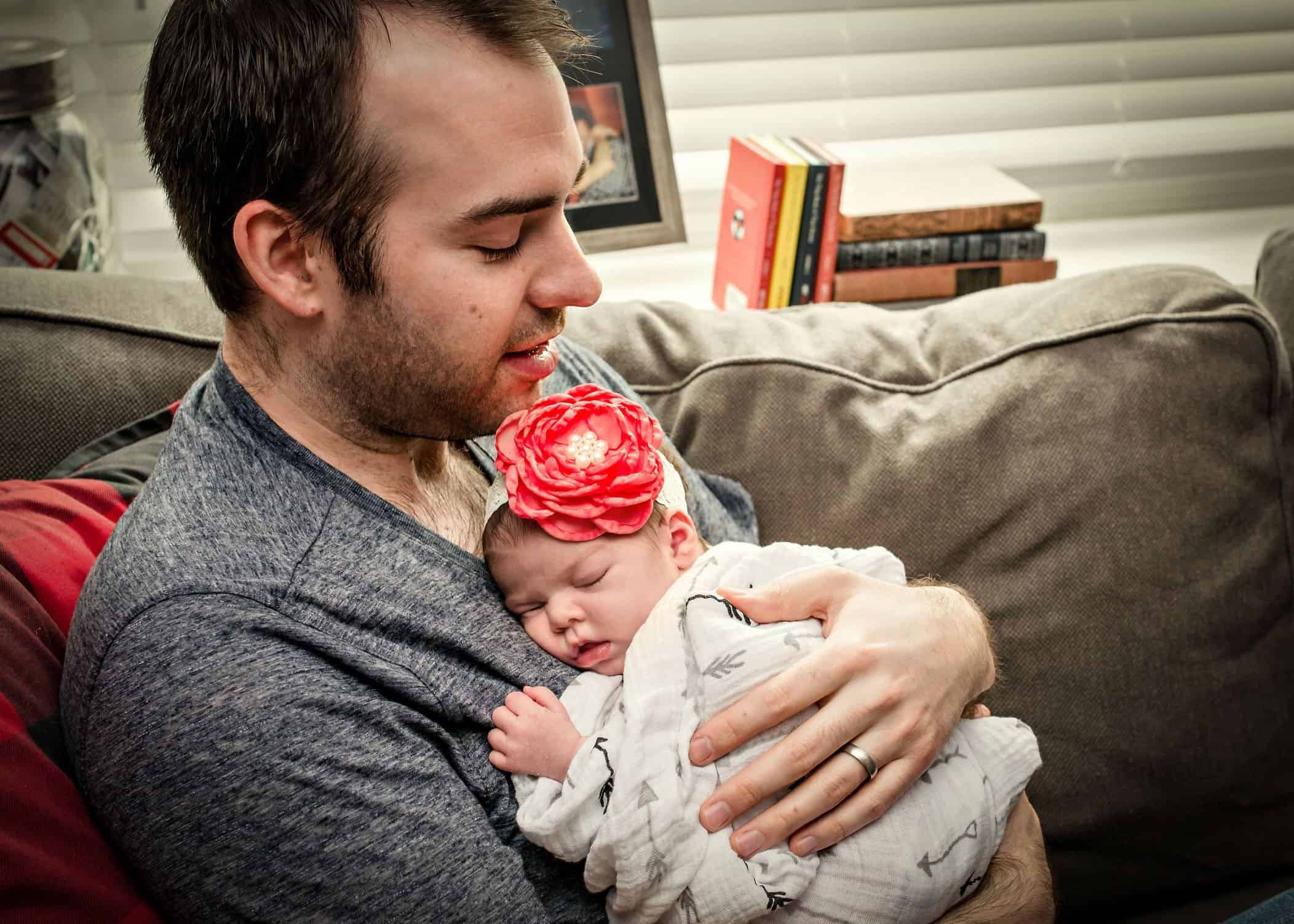 Dad holding sleeping newborn on his chest