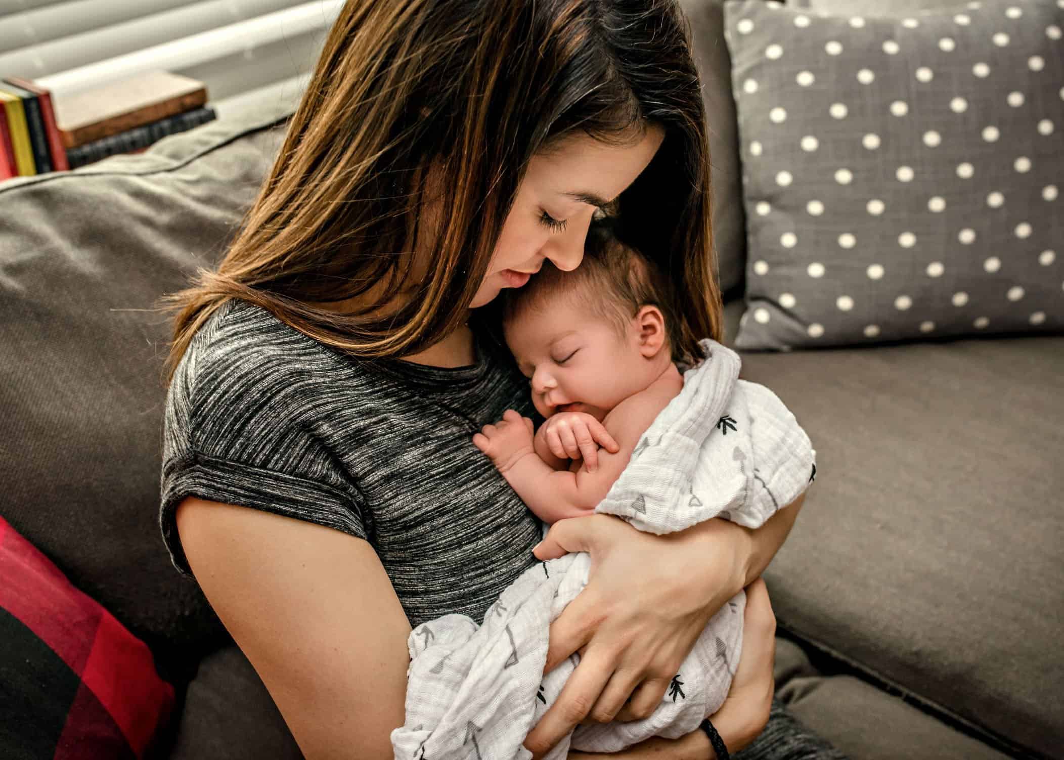 Mom holding sleeping newborn