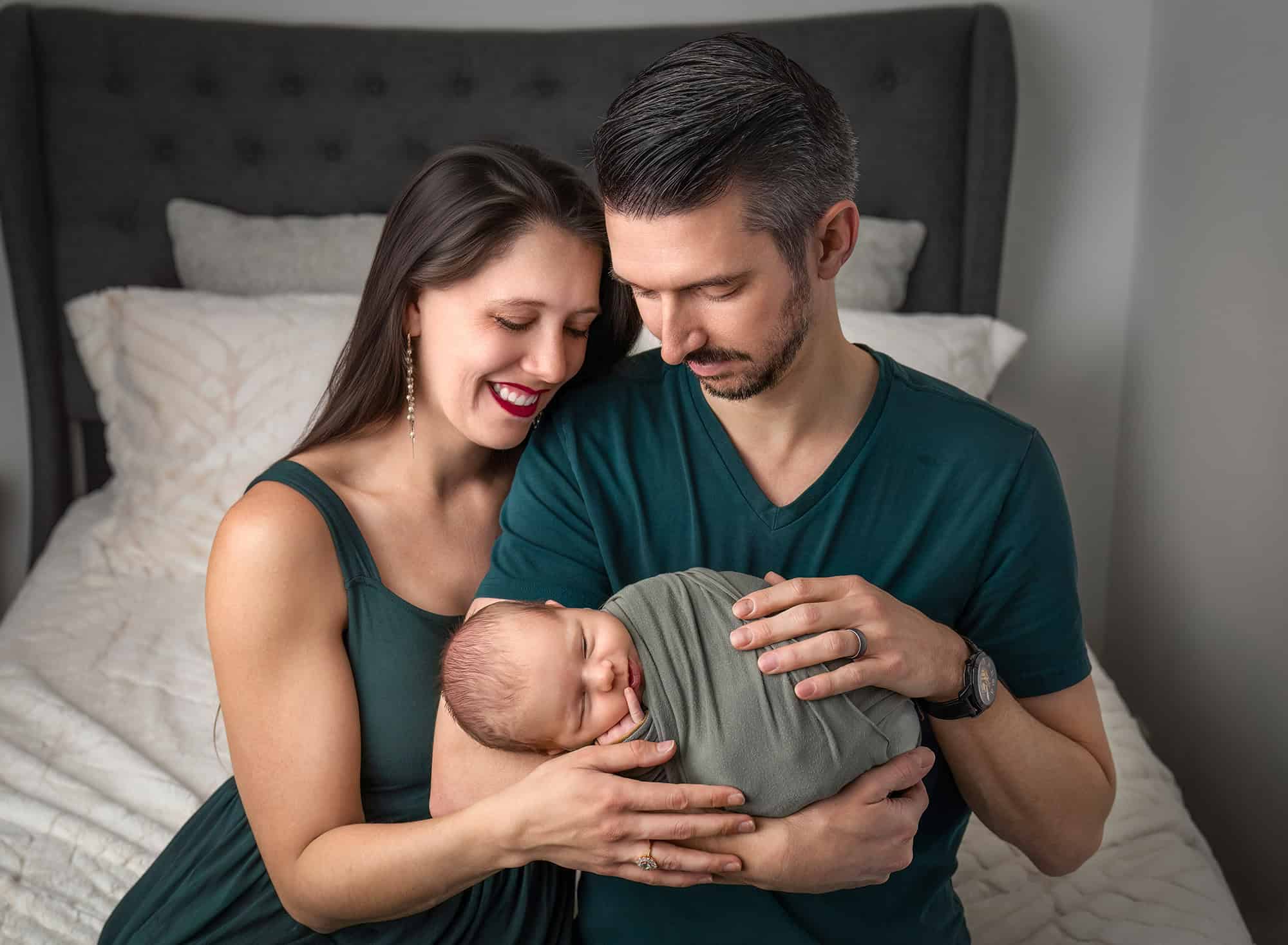 parents admiring sleeping baby Leif in close embrace