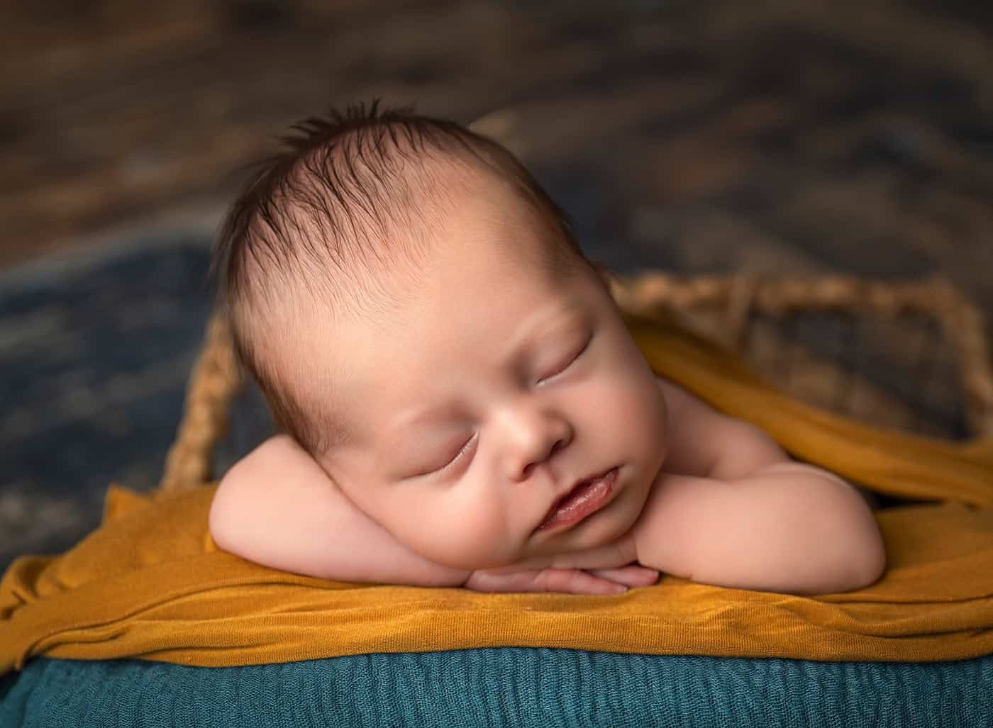newborn boy photos sleeping with his hands under his chin