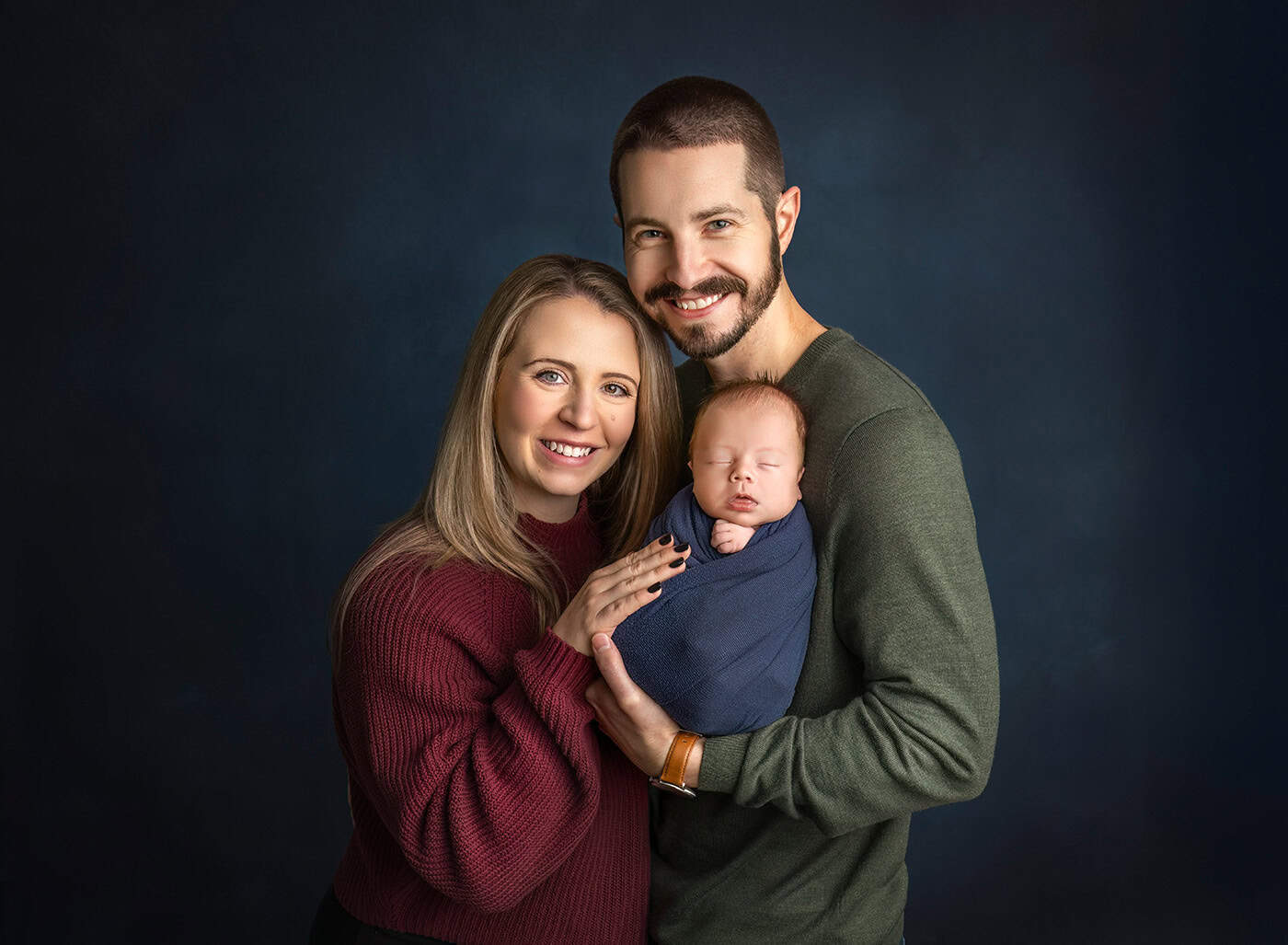 newborn boy photos mom dad and baby posed for the camera