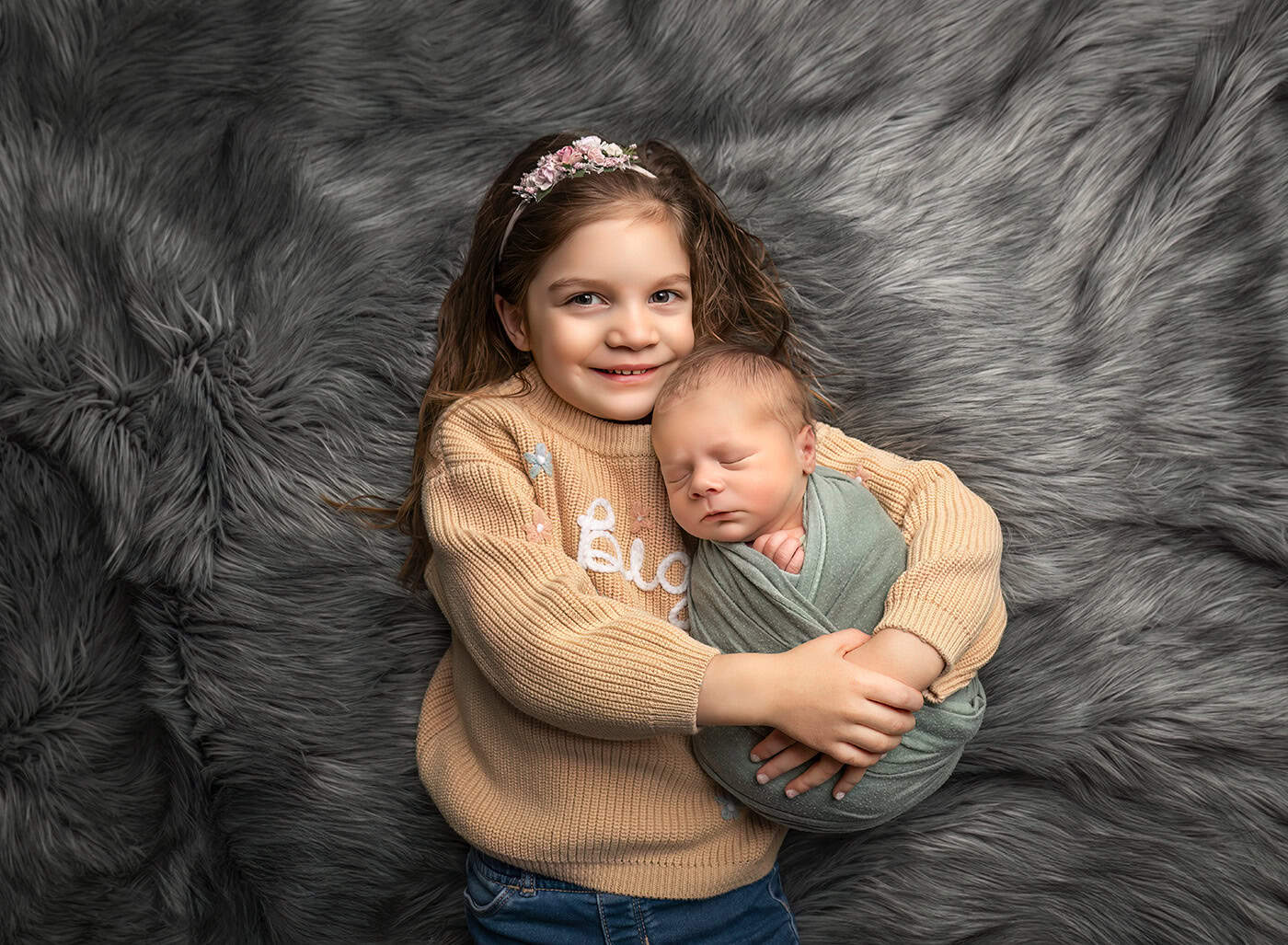 big sister and new baby brother Big sister Charlotte smiling while holding her newborn baby brother Teddy