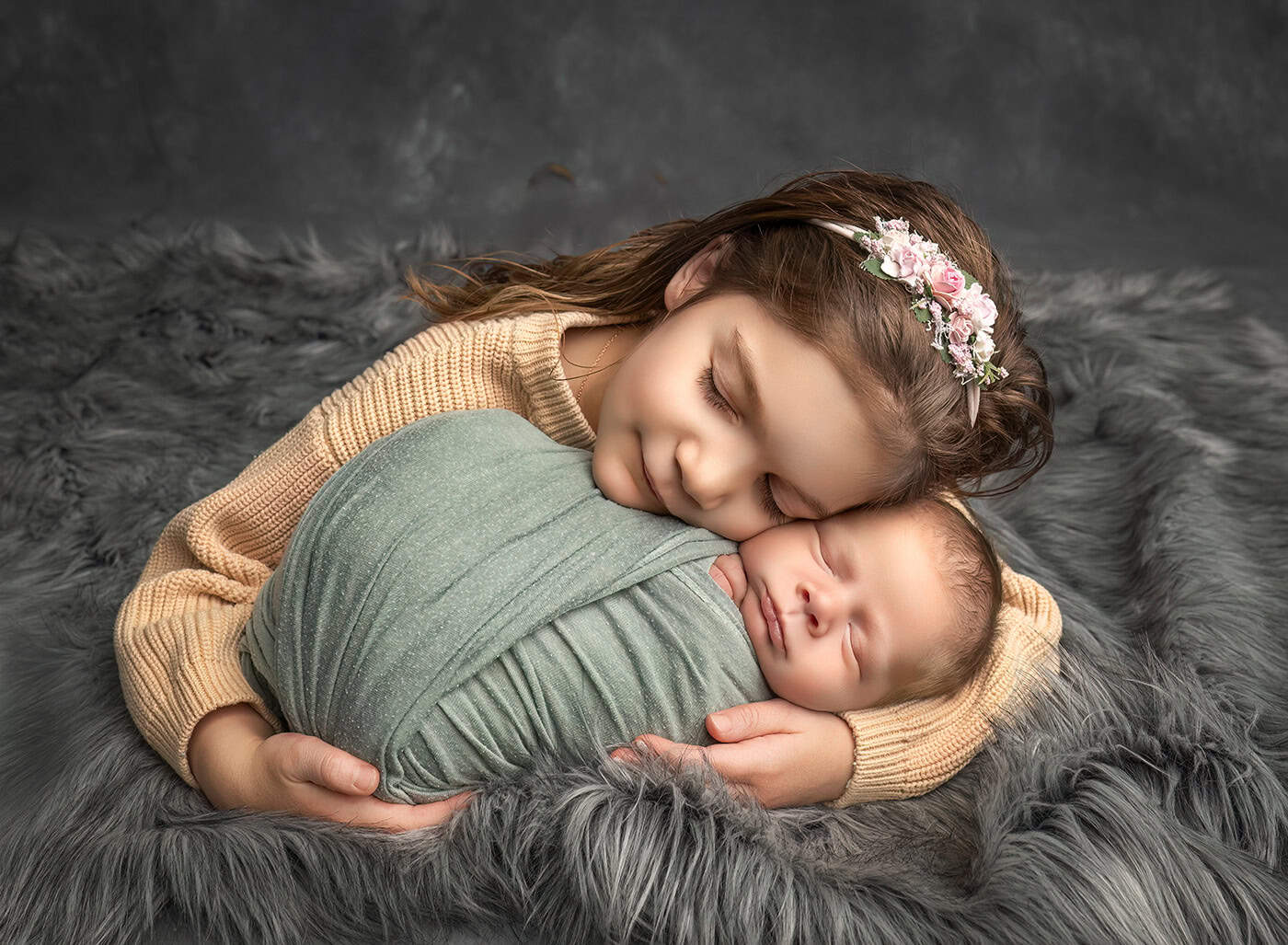 big sister and new baby brother snuggling