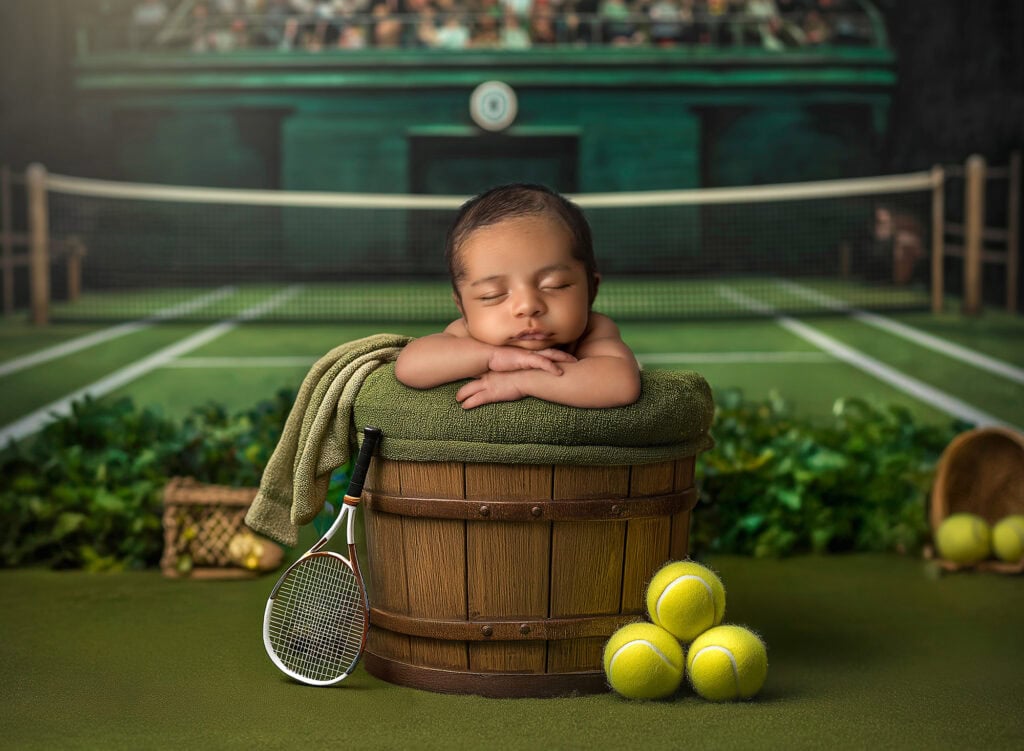 Connecticut newborn photographer baby sleeping in bucket on tennis court