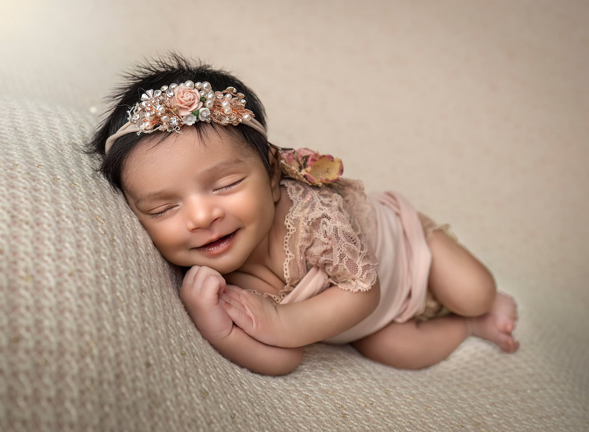Luxury Newborn Photographer Glastonbury CT Baby Anahita in a side-lying pose with peach lace and pearls