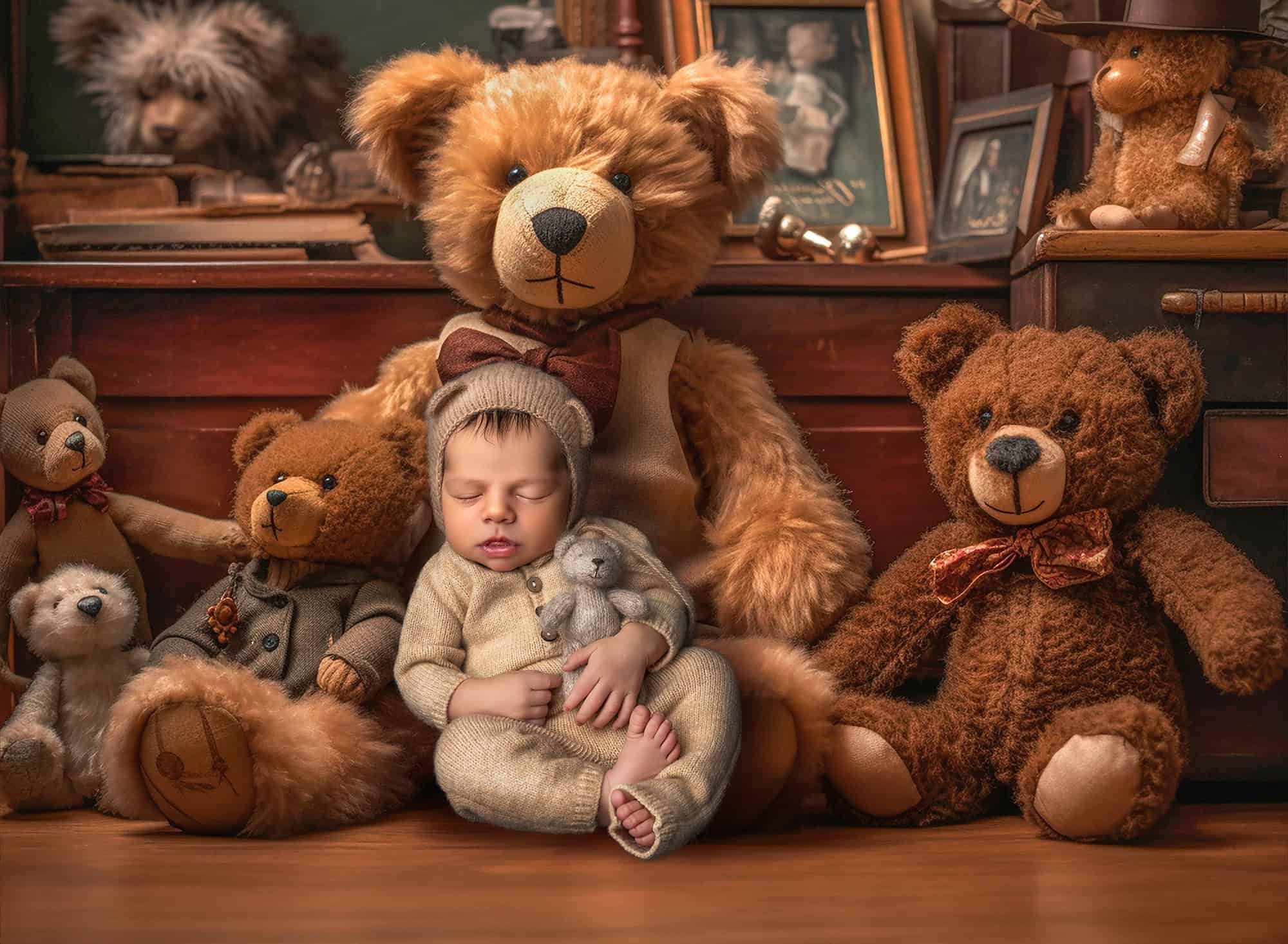 High-End Newborn Photography Connecticut newborn boy sleeping in a teddy costume with lots of other teddy bears