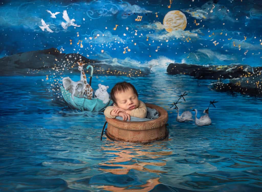 Creative composite of newborn Max floating peacefully in water with “A Silent Night” in the background