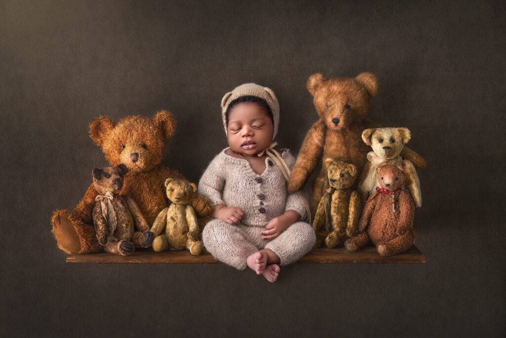 newborn photographer in Glastonbury baby sleeping on shelf with teddy bears