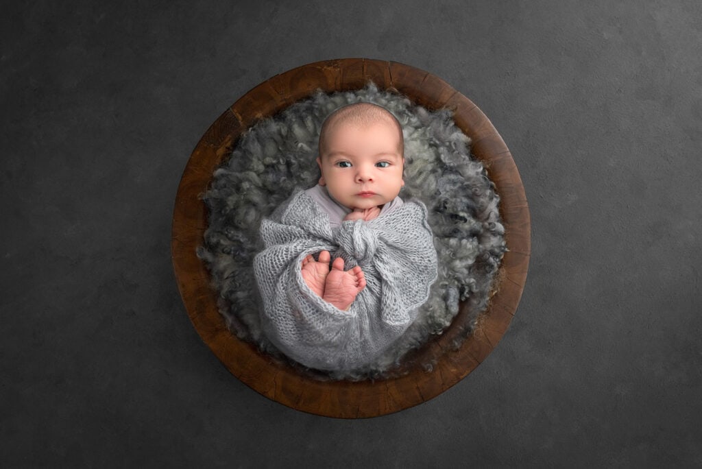 what is the best time for newborn photoshoot awake newborn boy wrapped in grey