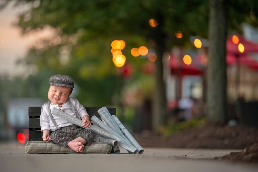 best time to do newborn photoshoot newborn dressed as newspaper boy sleeping on the job