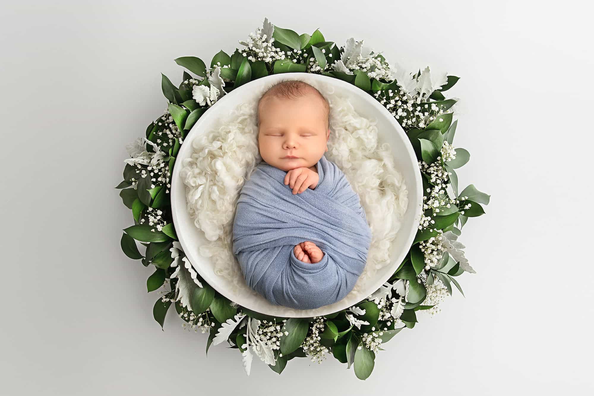 Natural newborn portrait in white wooden bowl with greenery at Glastonbury CT studio.