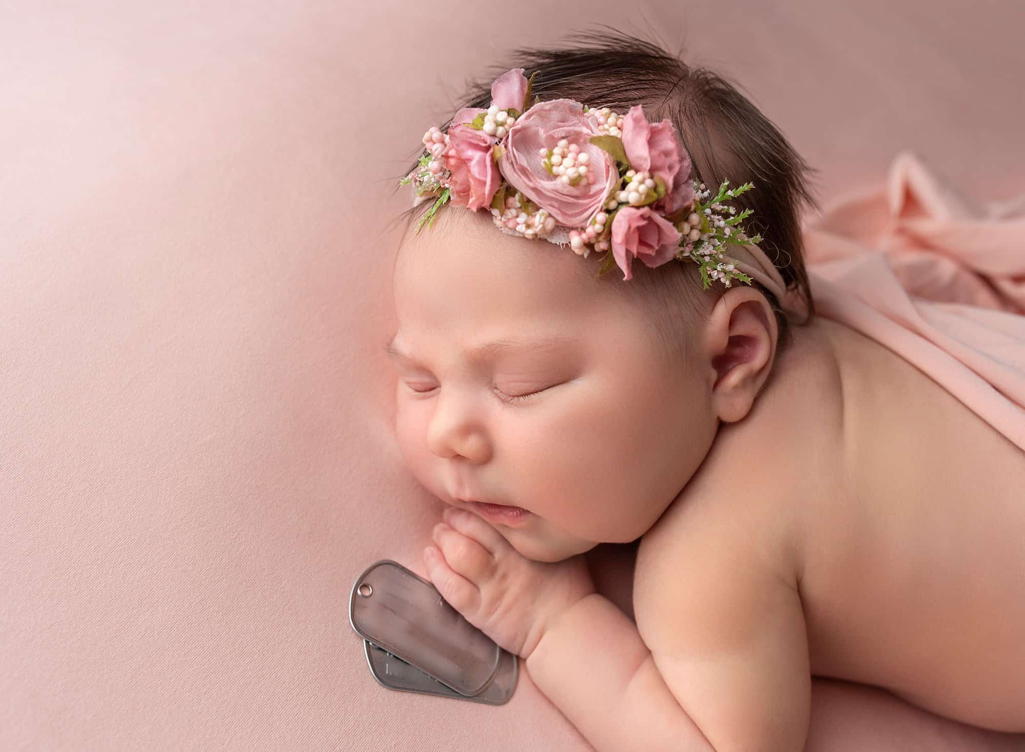 Deployed Military Newborn Photo newborn baby girl sleeping with her deployed dad's dog tags