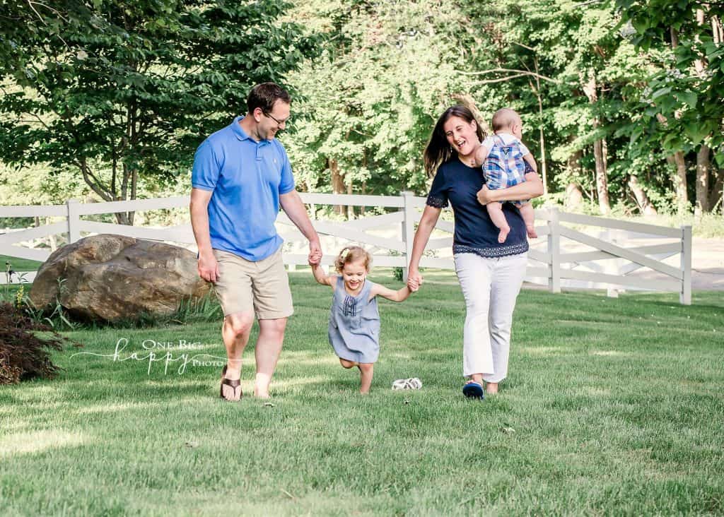 family of 4 walking while daughter tries to run ahead