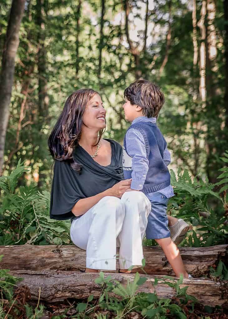 Mom listening to her young son tell her something outside in the garden