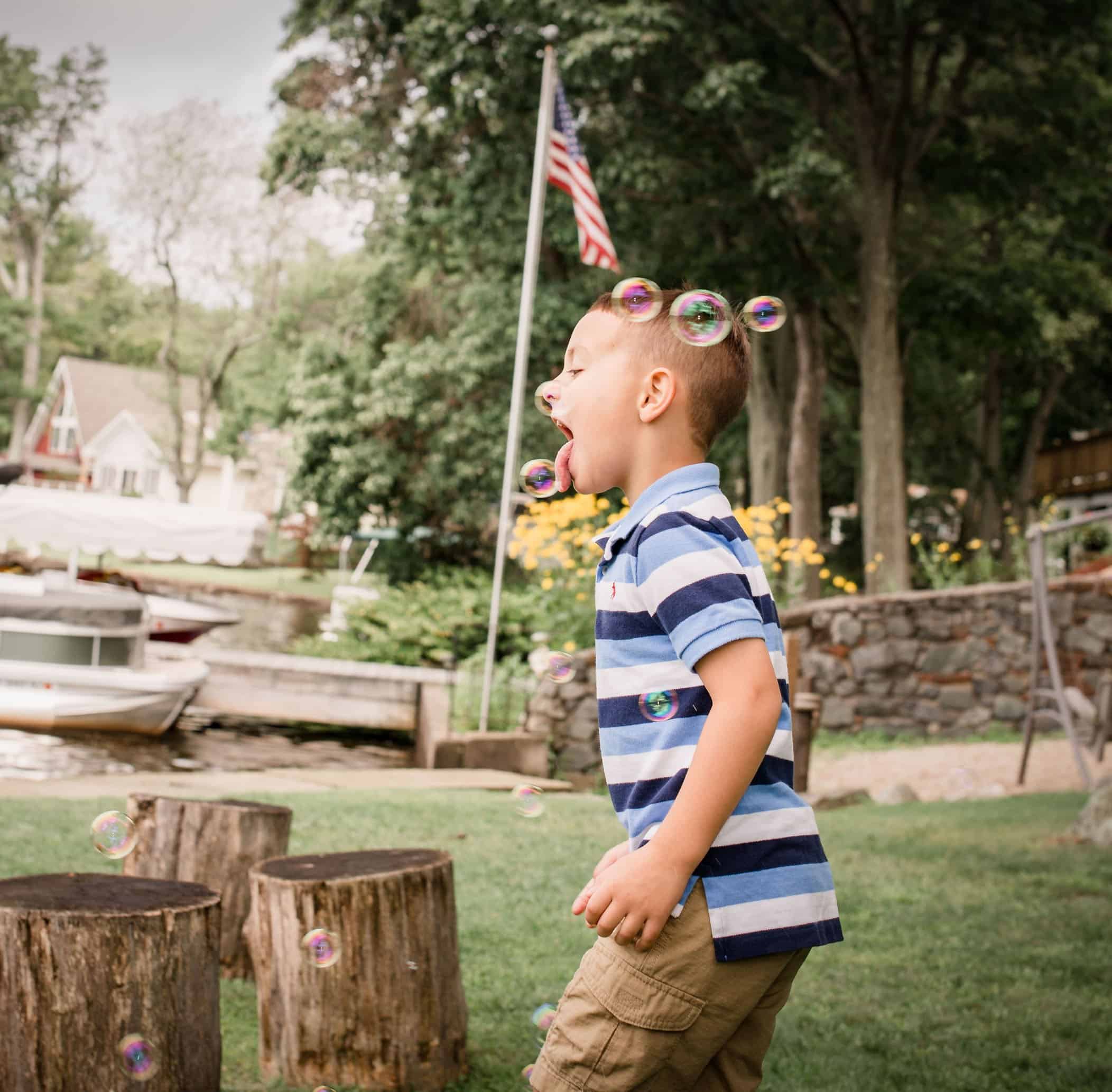5 year old brother catching a bubble on his tongue