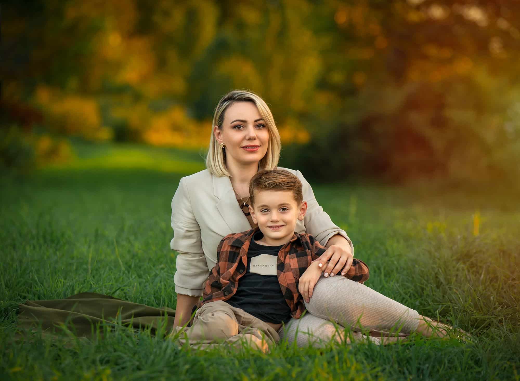 mother sitting in nature with son