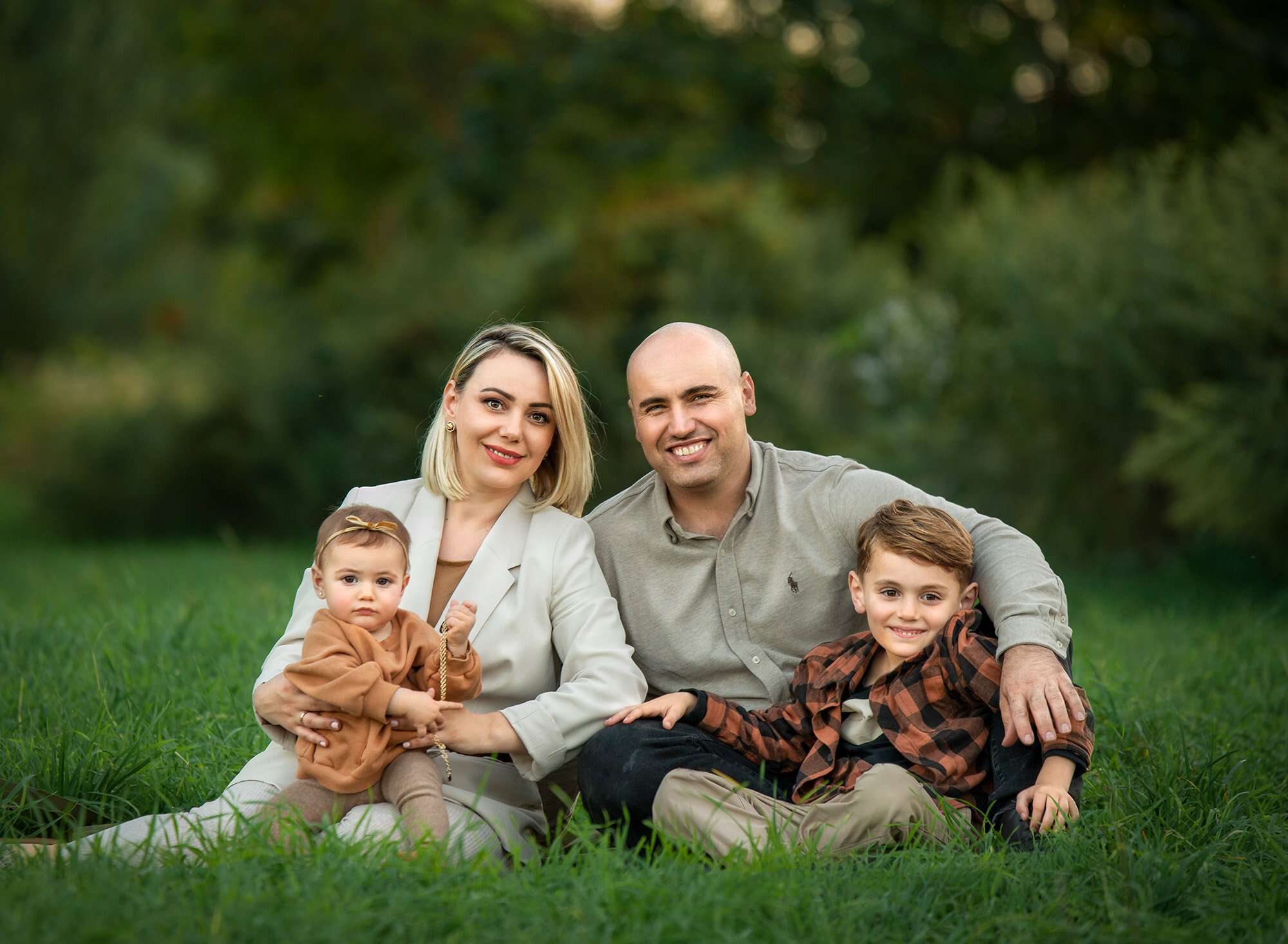 Outdoor family photoshoot in Glastonbury CT couple sitting with son and daughter in nature