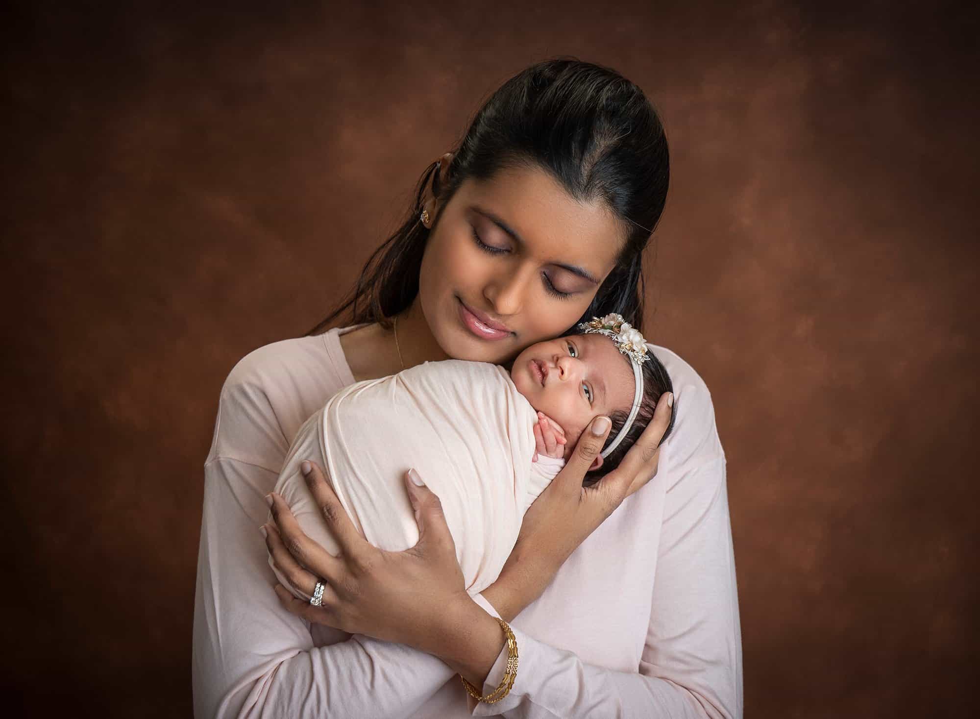 new mom cradling newborn baby girl