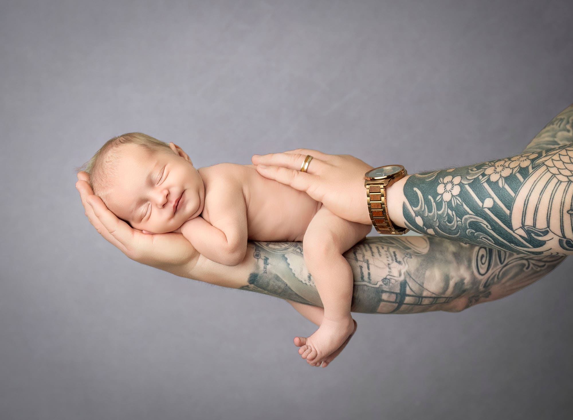newborn photography ct baby sleeping on dad's tattooed arm